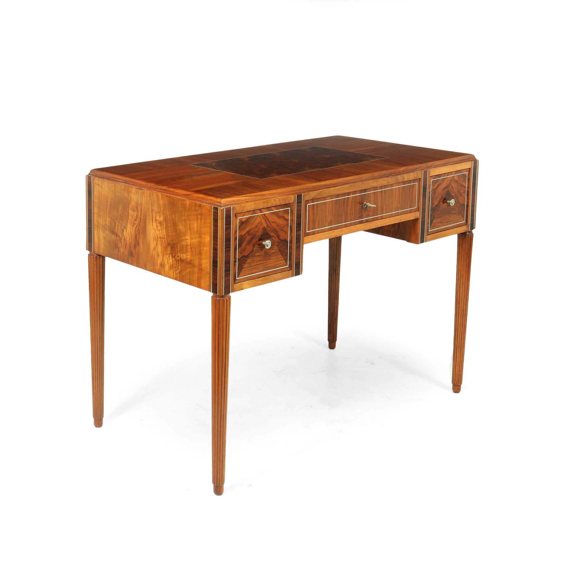 An exceptional quality figured walnut with solid silver and rosewood inlaid free standing writing table with burr walnut center on the top, the drawers all run smoothly, have solid drawer liners and hand cut dovetail joints front and back, the