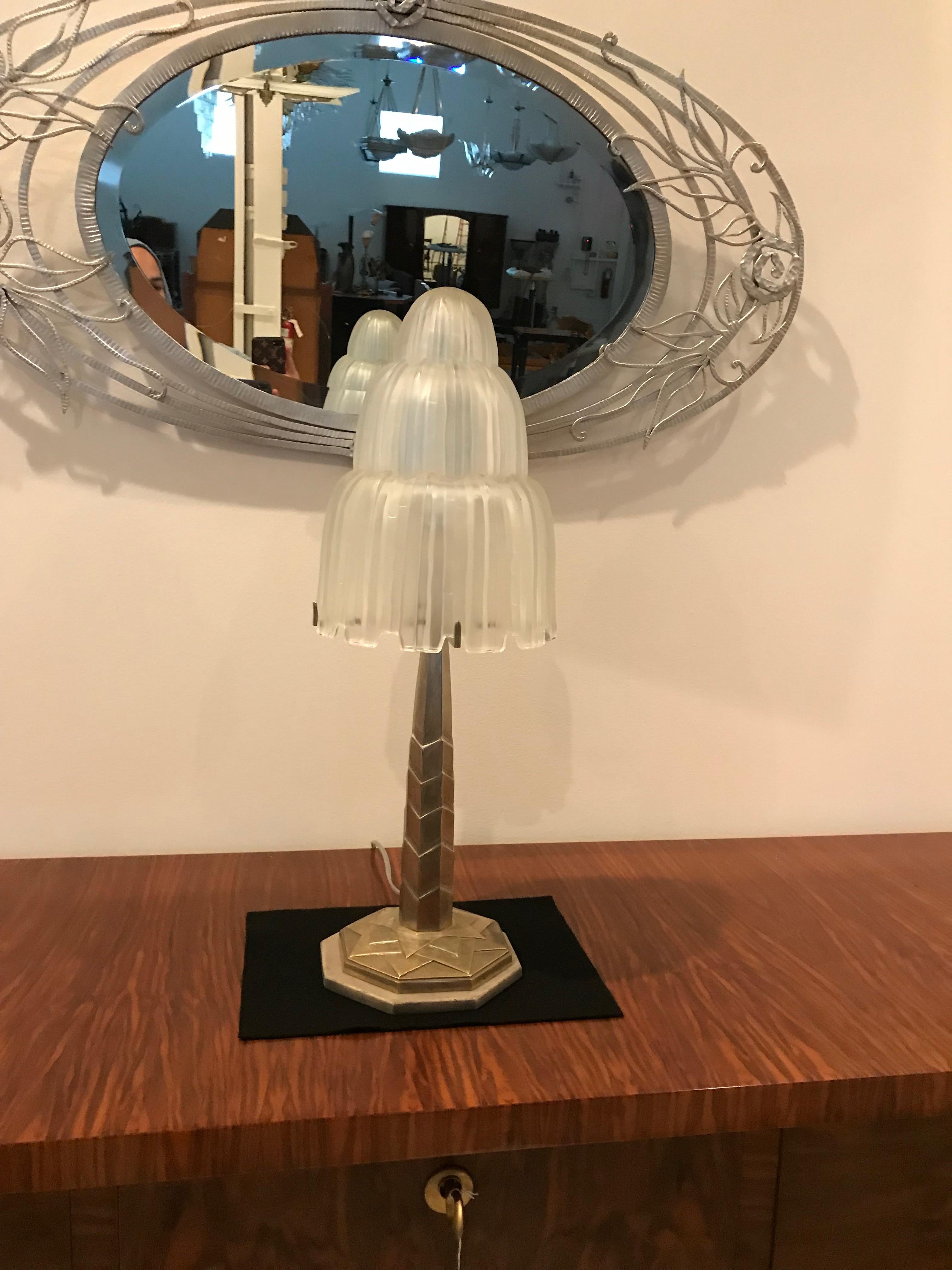 French Art Deco table lamp created by Marius Ernest Sabino. The shade is clear frosted glass with polished details referred to as the 