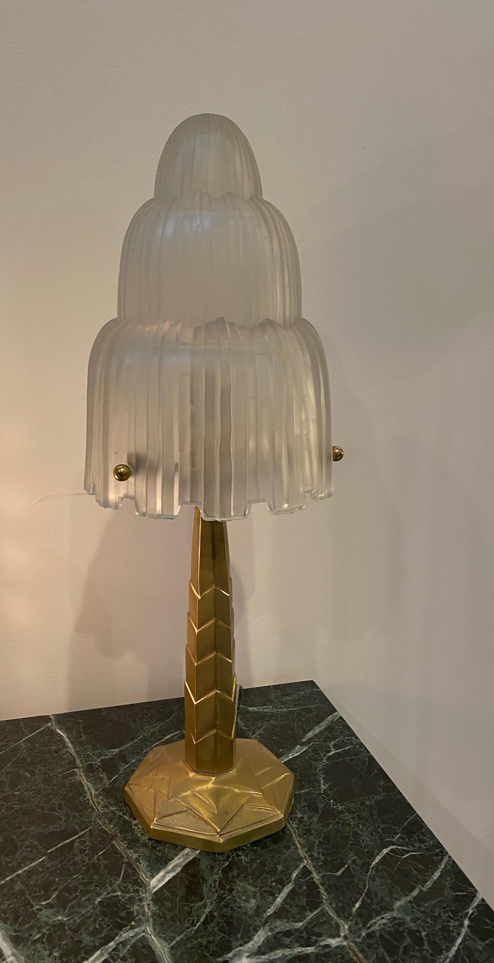 Single French Art Deco table lamp created by famous French artist Marius Ernest Sabino. The shade is clear frosted glass with polished details referred to as the 