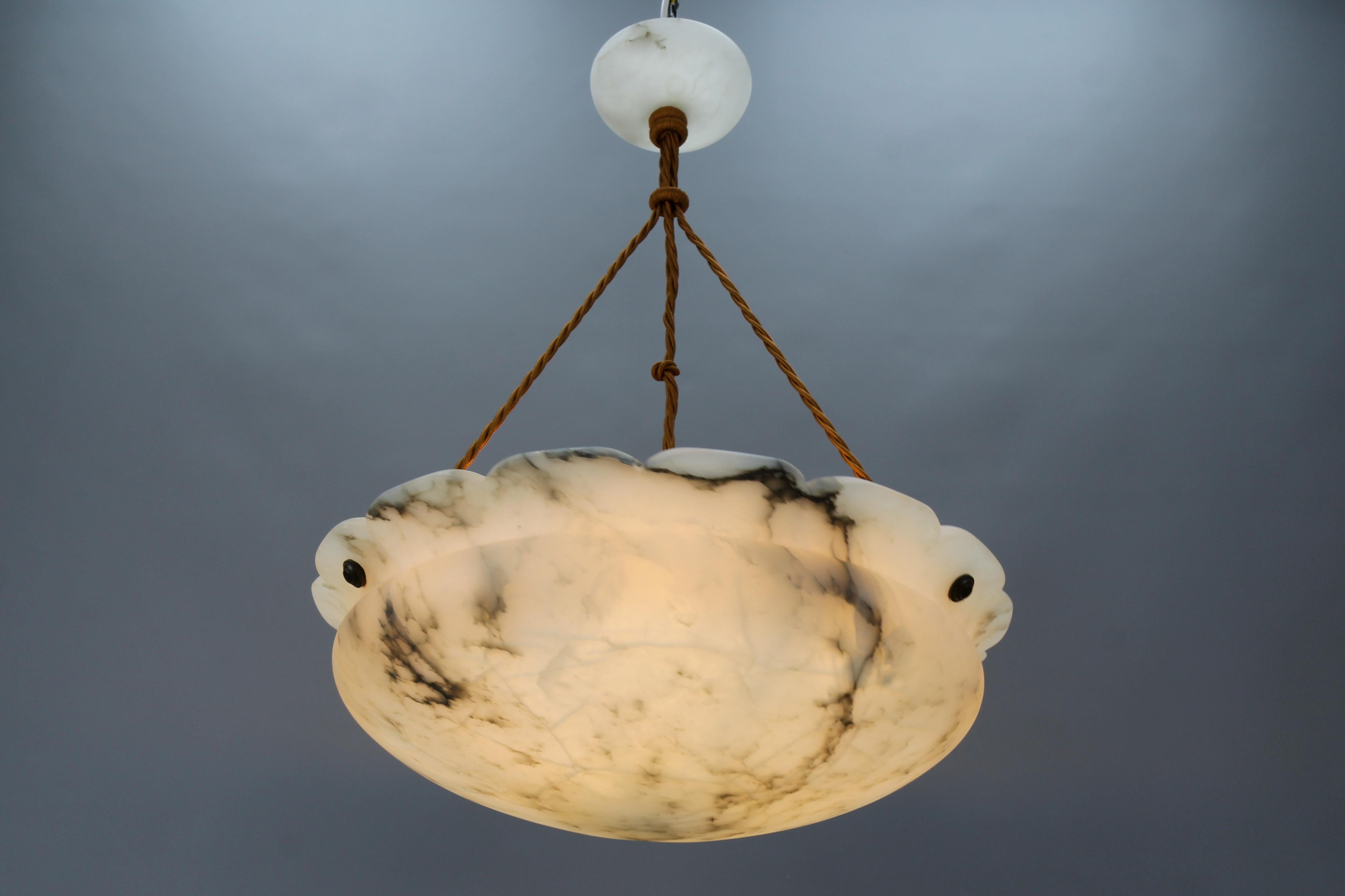 Gorgeous French Art Deco white alabaster pendant ceiling light fixture with dark brown and black veins. This beautifully veined, masterfully, in an elegant shape carved one-piece alabaster bowl is suspended by three wires and an alabaster ceiling