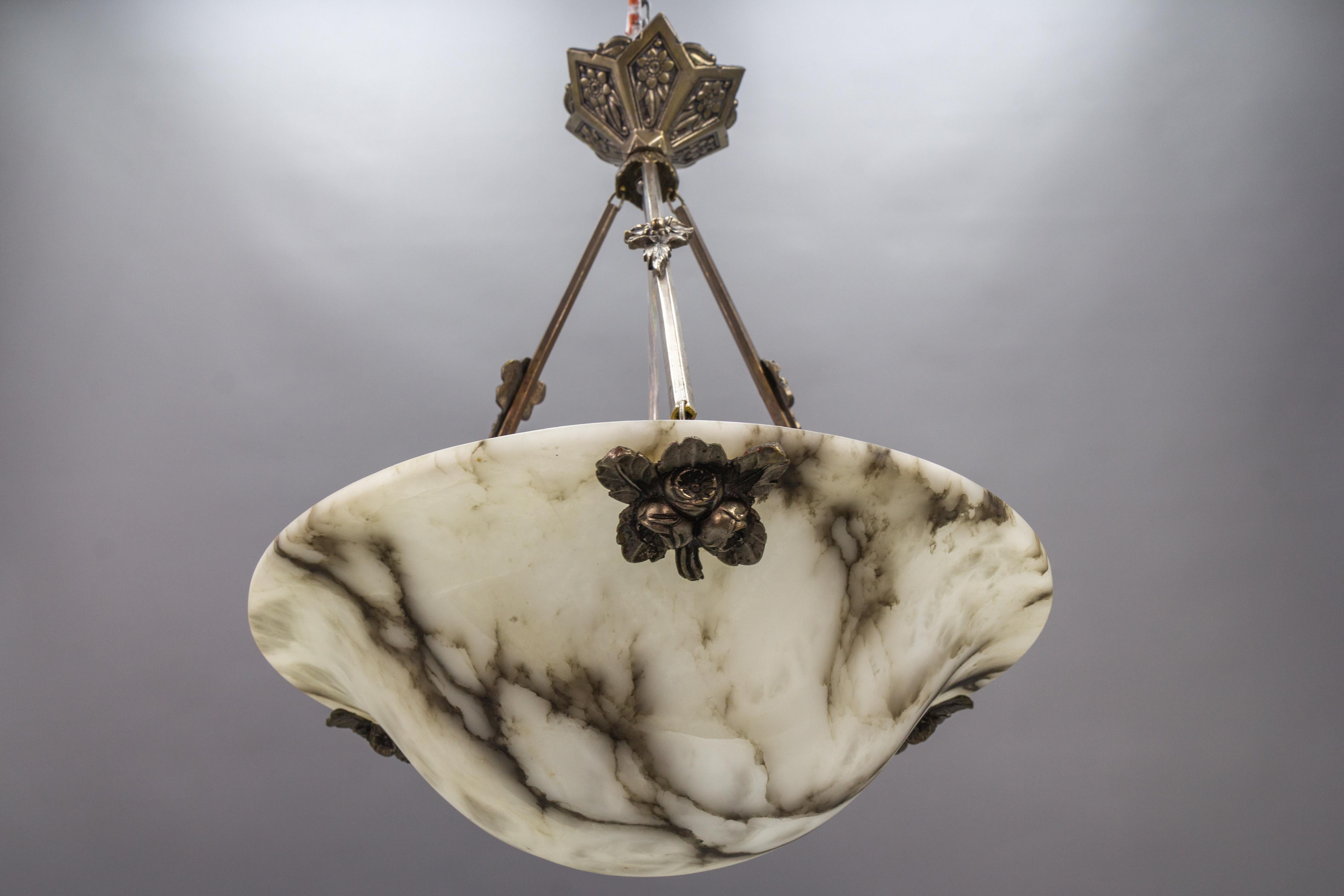 French Art Deco period black veined white alabaster pendant light fixture.
A wonderful alabaster pendant ceiling light fixture from circa the 1920s. Beautifully veined and masterfully carved white alabaster bowl suspended by chromed brass fixture