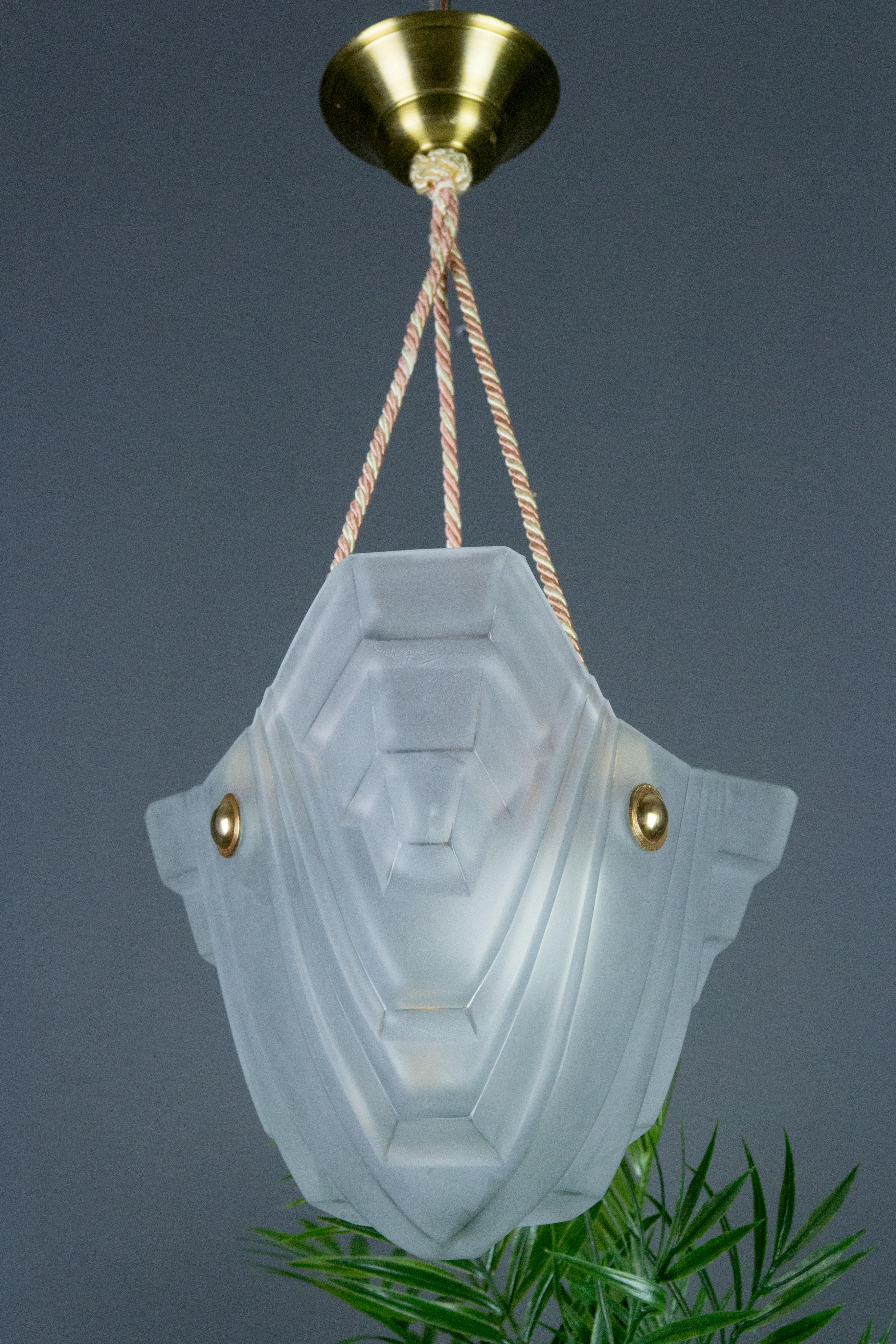 This beautiful French Art Deco pendant chandelier features an unusual shape of a white frosted glass shade, made and marked by Degué.
Held by three cords with a brass canopy. One socket for E27 (E26) size light bulb.
Dimensions: height 50 cm /