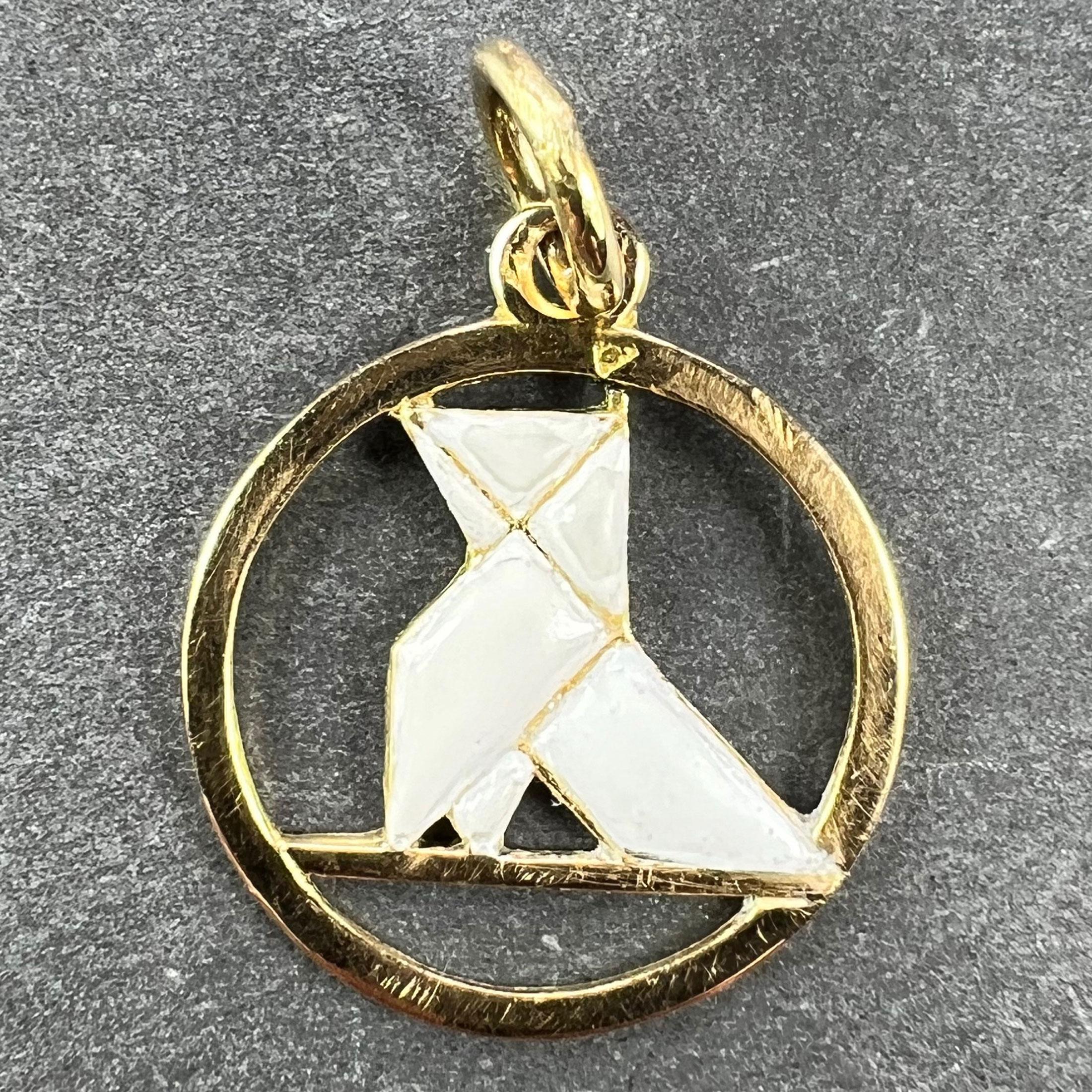 A French Art Deco 18 karat (18K) yellow gold and white enamel charm pendant designed as an origami bird. Stamped with the eagle’s head for 18 karat gold and French manufacture along with an unknown maker's mark.

Dimensions: 1.8 x 1.6 x 0.15 cm (not