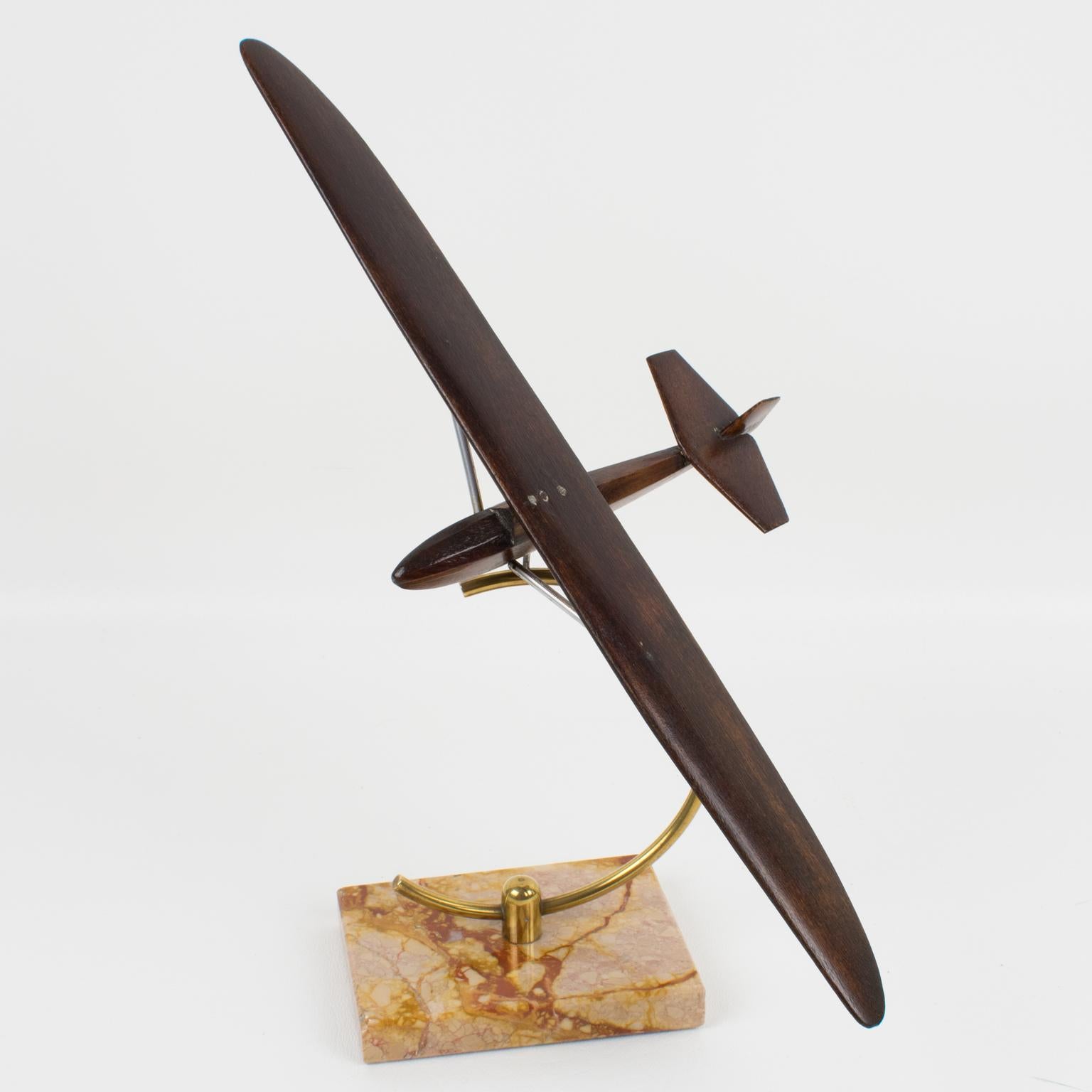 Lovely French Art Deco wooden sculpture aviation model featuring a glider airplane or sailplane. Square marble base with brass holder. No visible maker's mark.
Measurements: 
Overall: 8.69 in. wide (22 cm) x 5.69 in. deep (14.5 cm) x 10.63 in. high