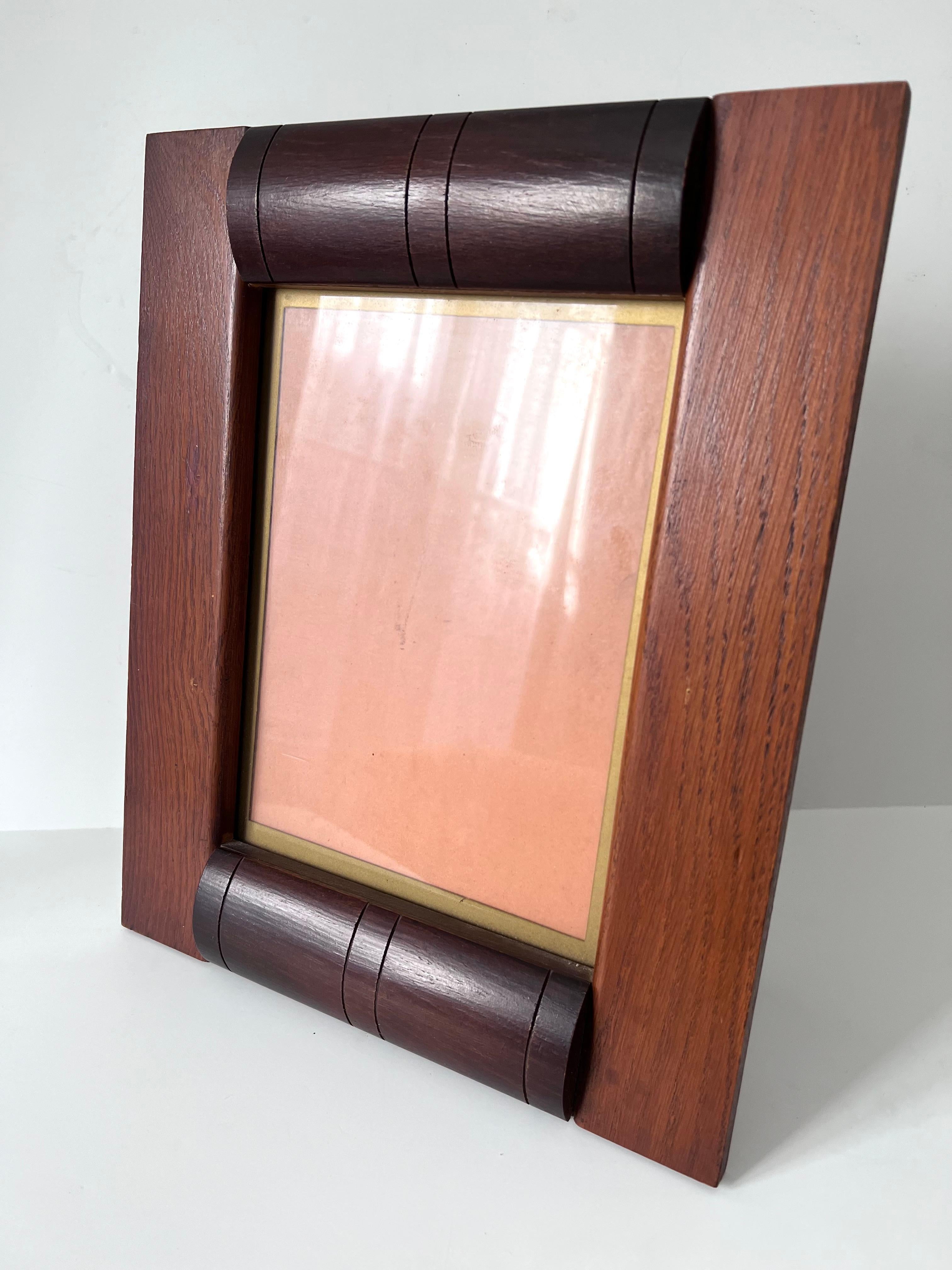 Acquired in Paris France, a stunning Art Deco, Arts and Crafts wooden picture frame. Likely hand made and out of two different woods. Simple, yet stunning. The glass has a gold rim which adds to the overall detail of the frame. 

A compliment to
