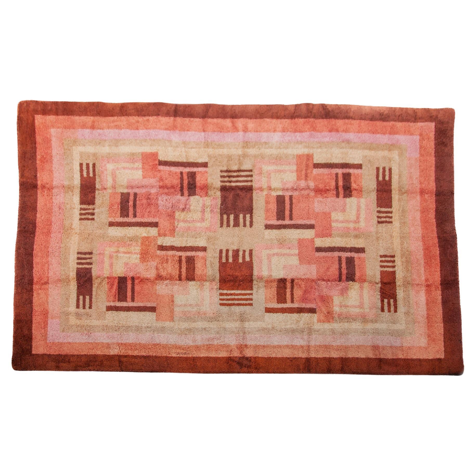 Large four meter French Art Deco futurist hand woven wool rug with abstract art.  Handcrafted in the 1930s this rug features a geometric design in Bauhaus style, with the color palette consisting in pink, ecru and brown tones framed with a dark