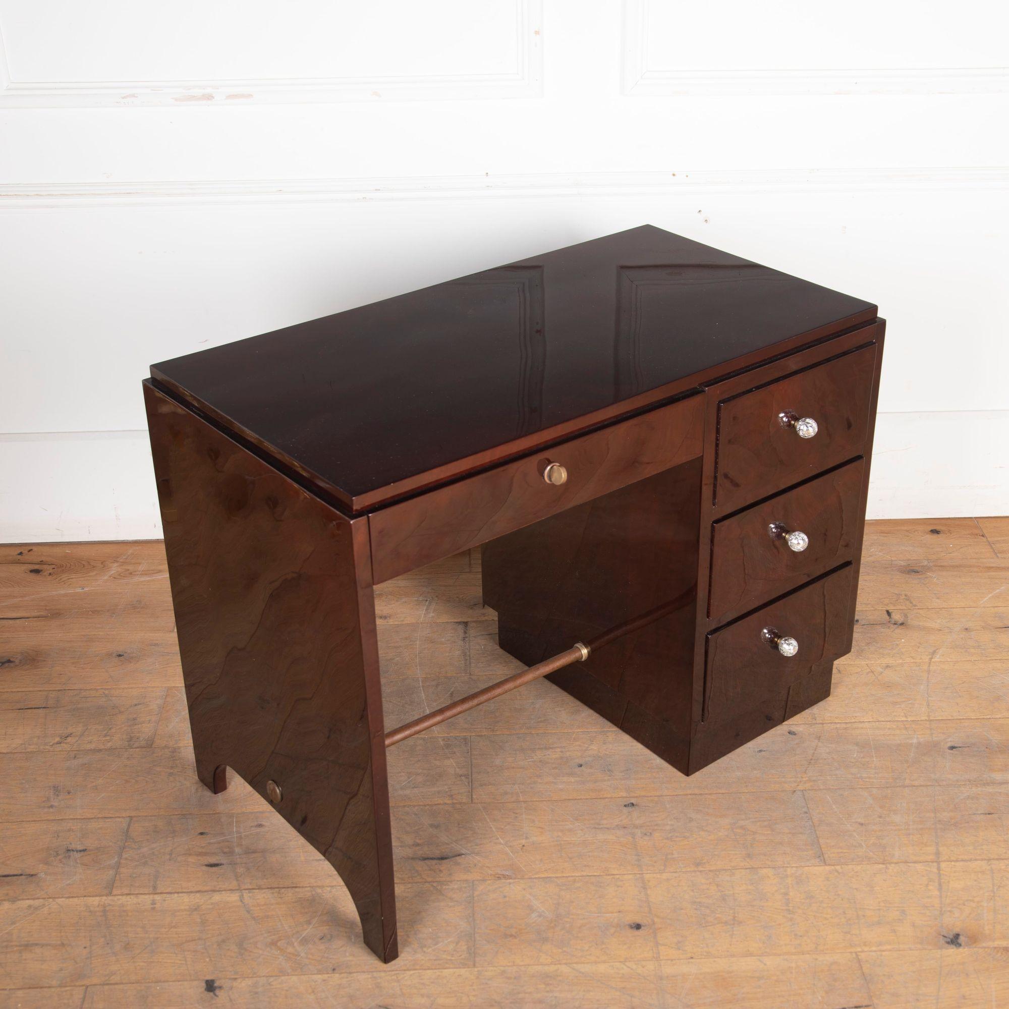 Charming French Art Deco ladies writing desk. 
This desk is covered with walnut veneer that is in a palisander colour.
It has three chests on the right side and one in the center. The whole is decorated with three new stylish handles.