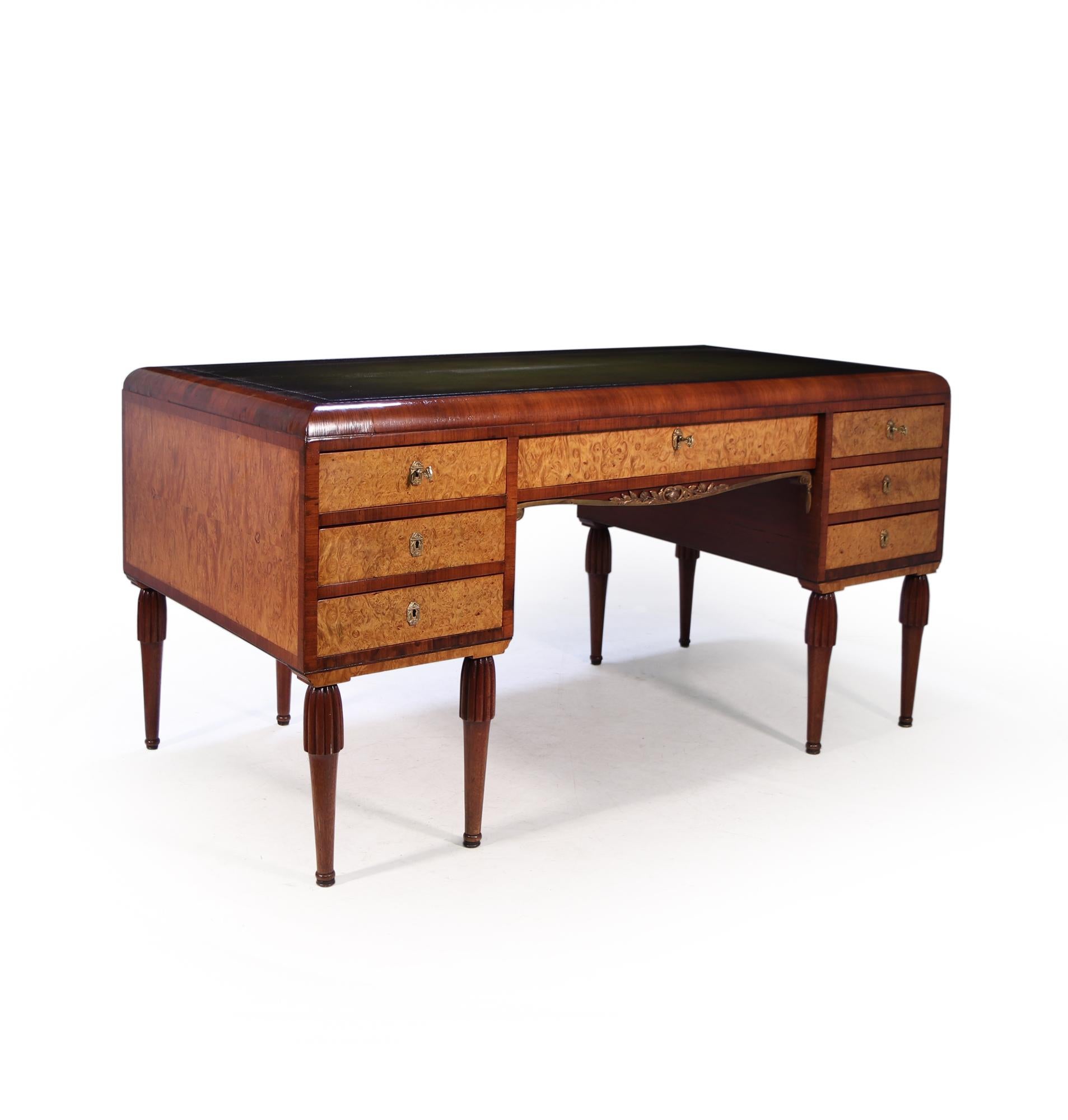 Produced in France around 1925 this Art Deco desk with gilt bronze mounts and escutcheons very much in the manner of and attributable to Maurice Dufrene. Hand-made in Paris around 1925 from prime selected Mahogany, Oak and burr maple , the desk has