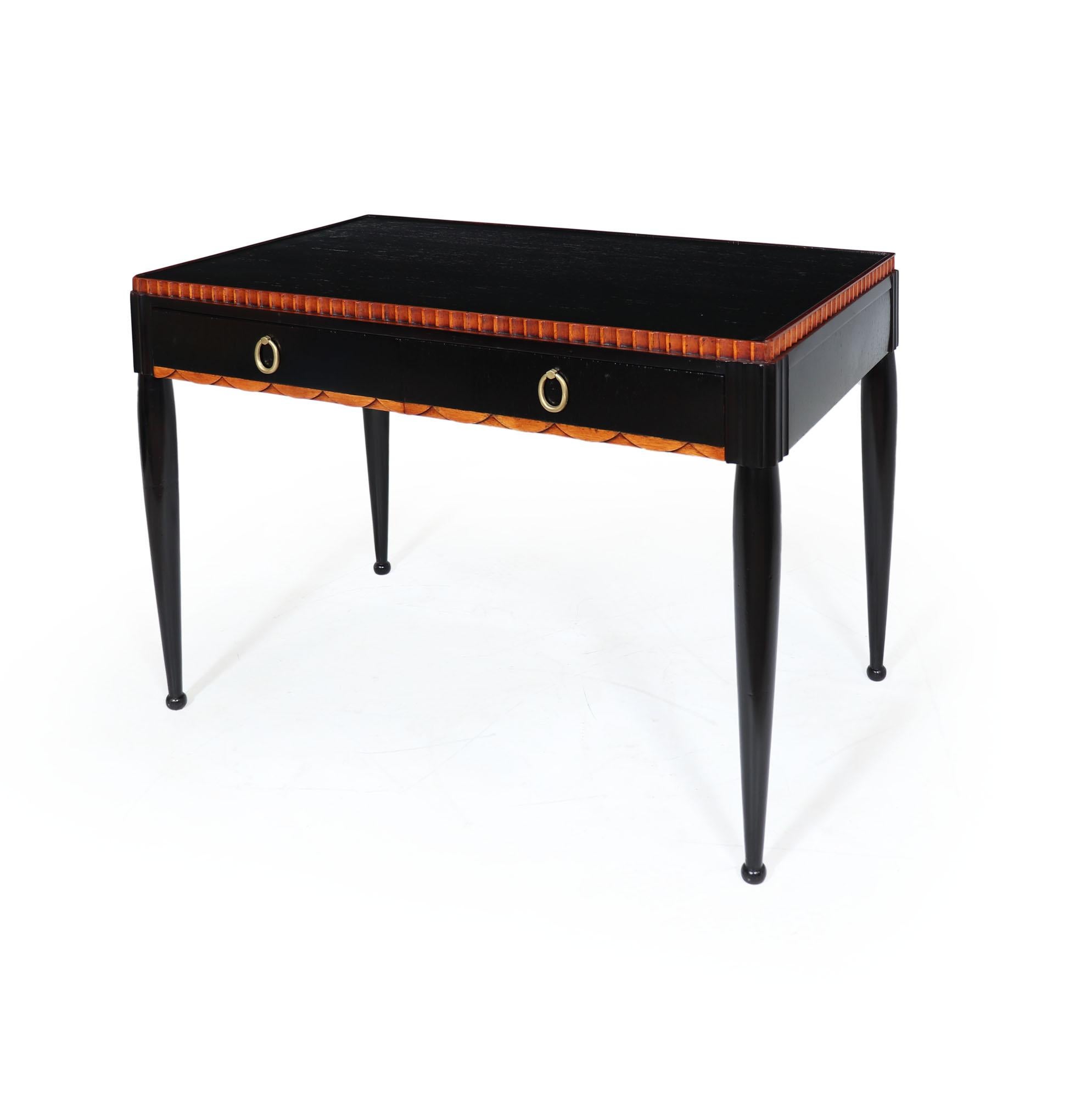 Art Deco writing table produced in France in the 1930’s from Mahogany, having an ebonised body with fluted detail, the desk has two drawers and brass ring handles this stands on turned legs
Age: 1930

Style: Art Deco

Origin :
