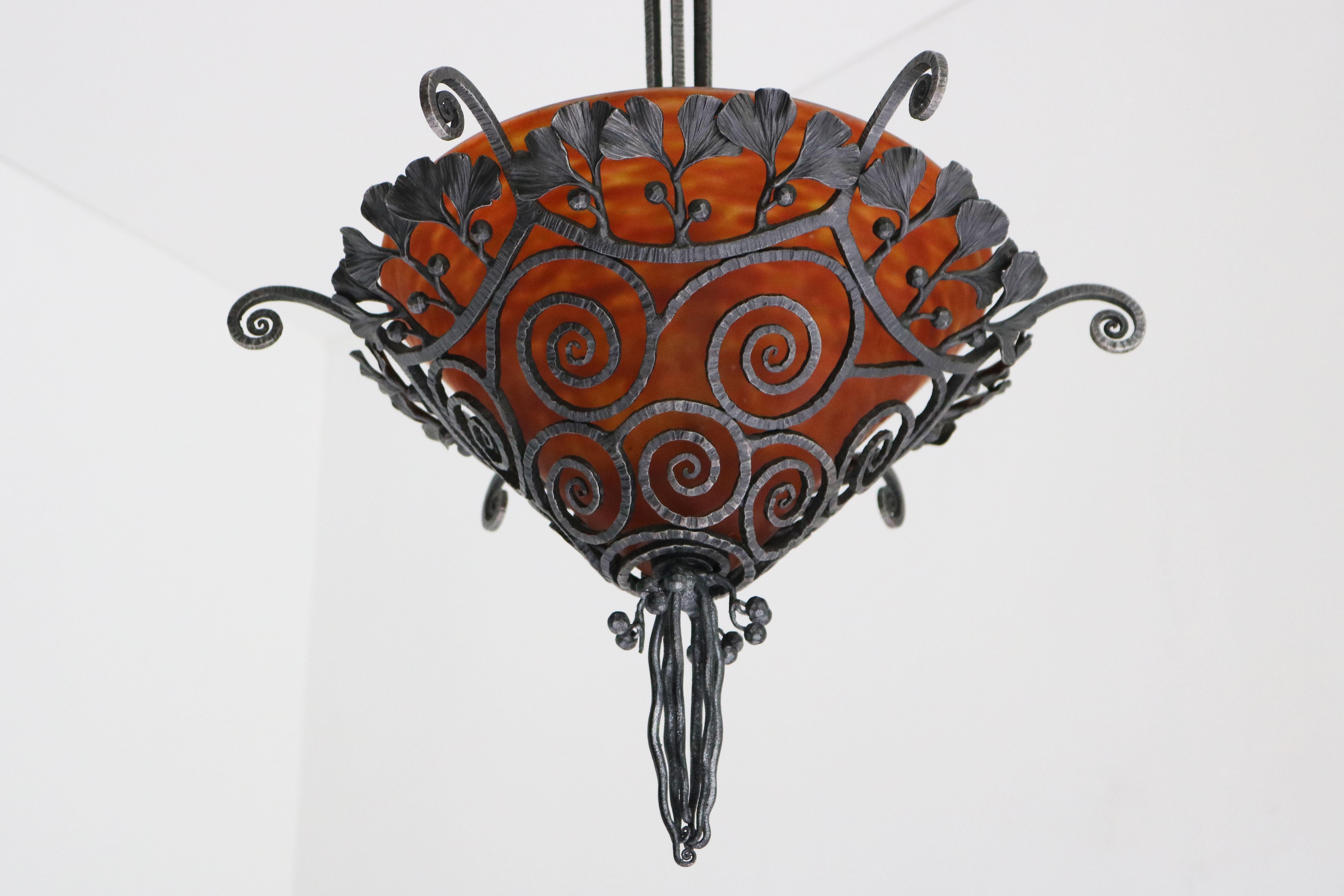 Stylish & Timeless! This breathtaking French art deco chandelier / pendant light by Edgar Brandt & Daum Nancy 1920. 
Incredible craftsmanship in the hand made wrought iron frame showing the favorite design of Edgar brandt: Gingko leaves and berries.