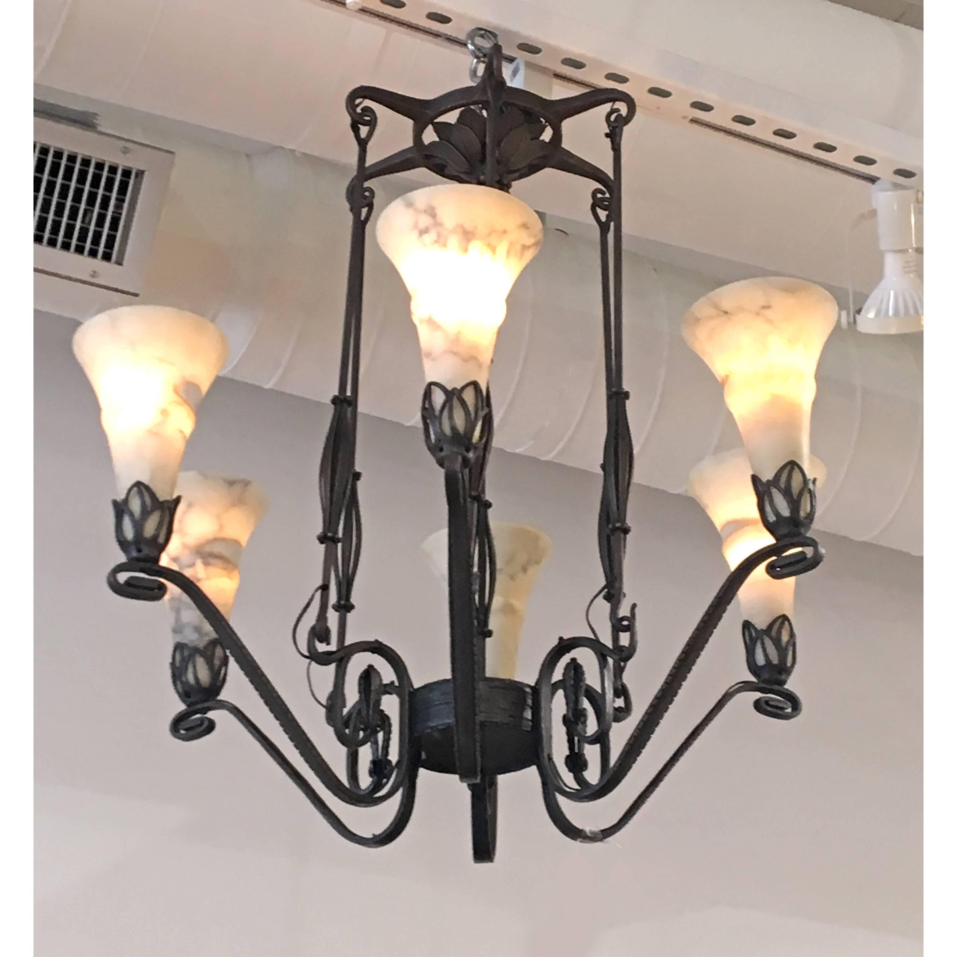 A beautiful and decorated wrought iron chandelier with alabaster shades by E. Brandt.
Made in France,
circa 1920.
Signed: 