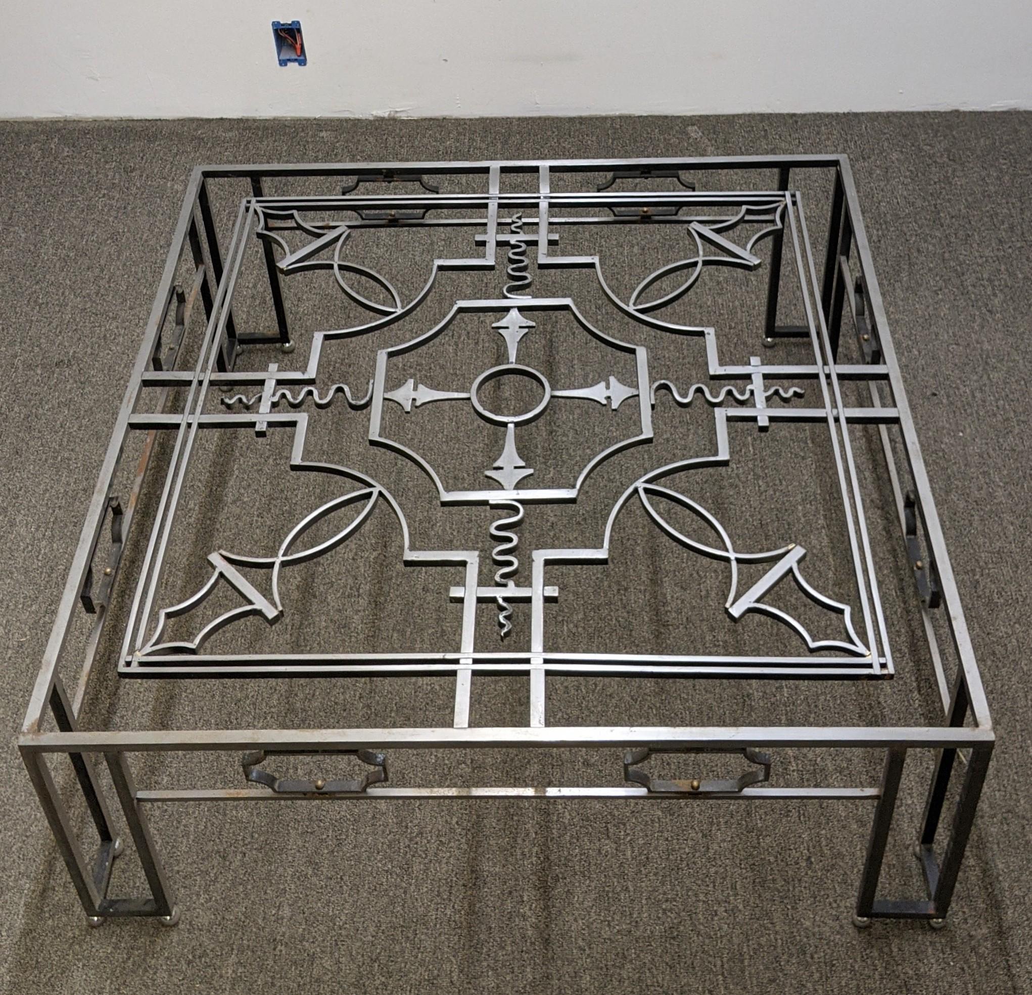 A French Art Deco wrought iron square shaped coffee table, 1940's. With patterns motifs throughout, with angular legs complemented by three balls. Complimentary drop-off to the tri-state area. We are the rare source specializing in French Art Deco
