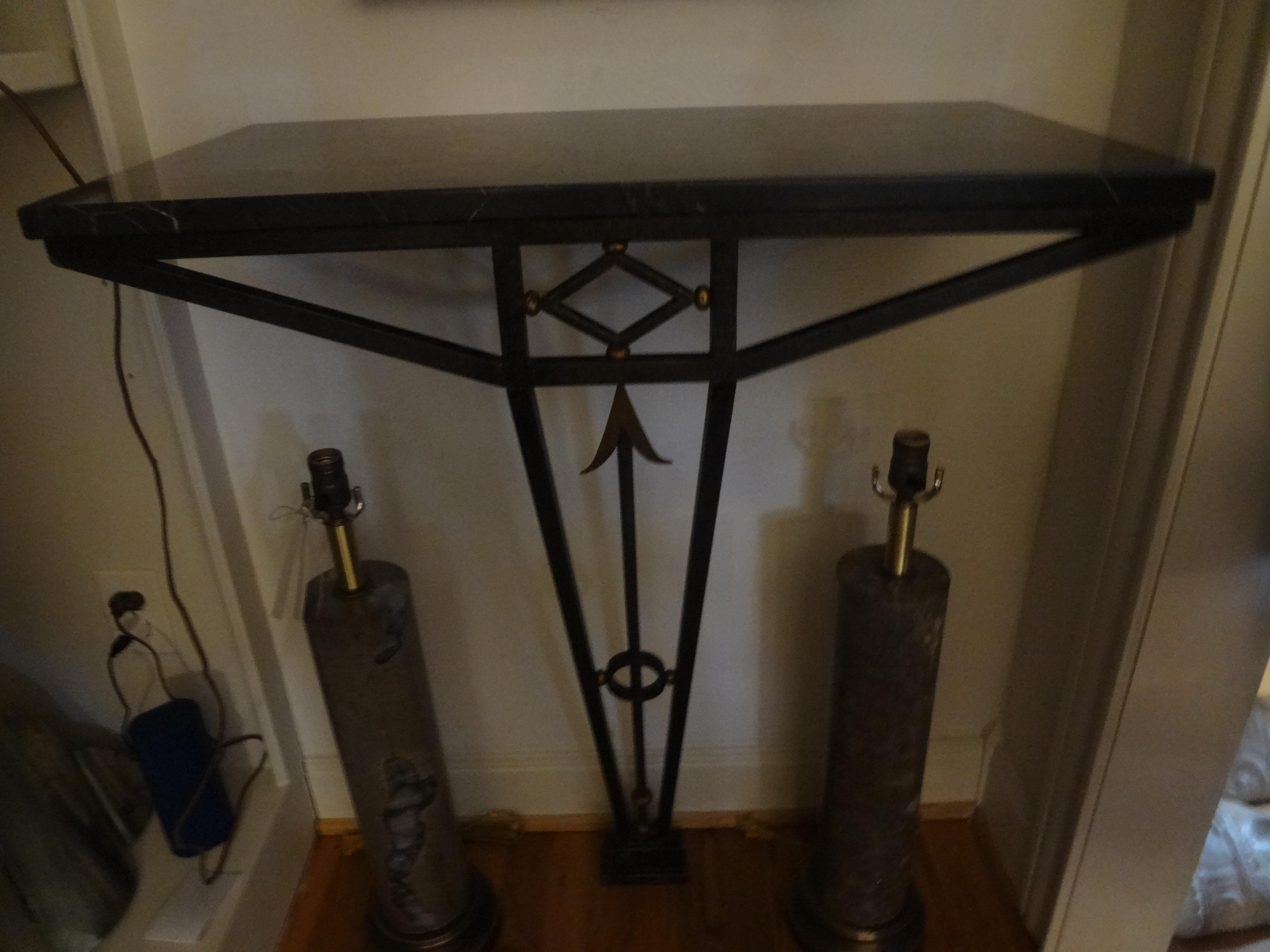 Stunning French Art Deco neoclassical style hand forged wrought iron console table with marble top. This gorgeous period French deco Edgar Brant inspired wrought iron console table has a fabulous arrow design, gilt trim, a beautiful marble top and