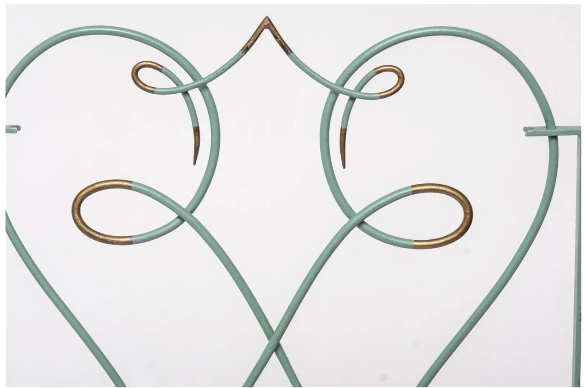 A pair of 1940s French Art Deco style wrought iron fire screens, attributed to Gilbert Poillerat. Sage green paint with gilt accents. These are meant to be used together as a set. 