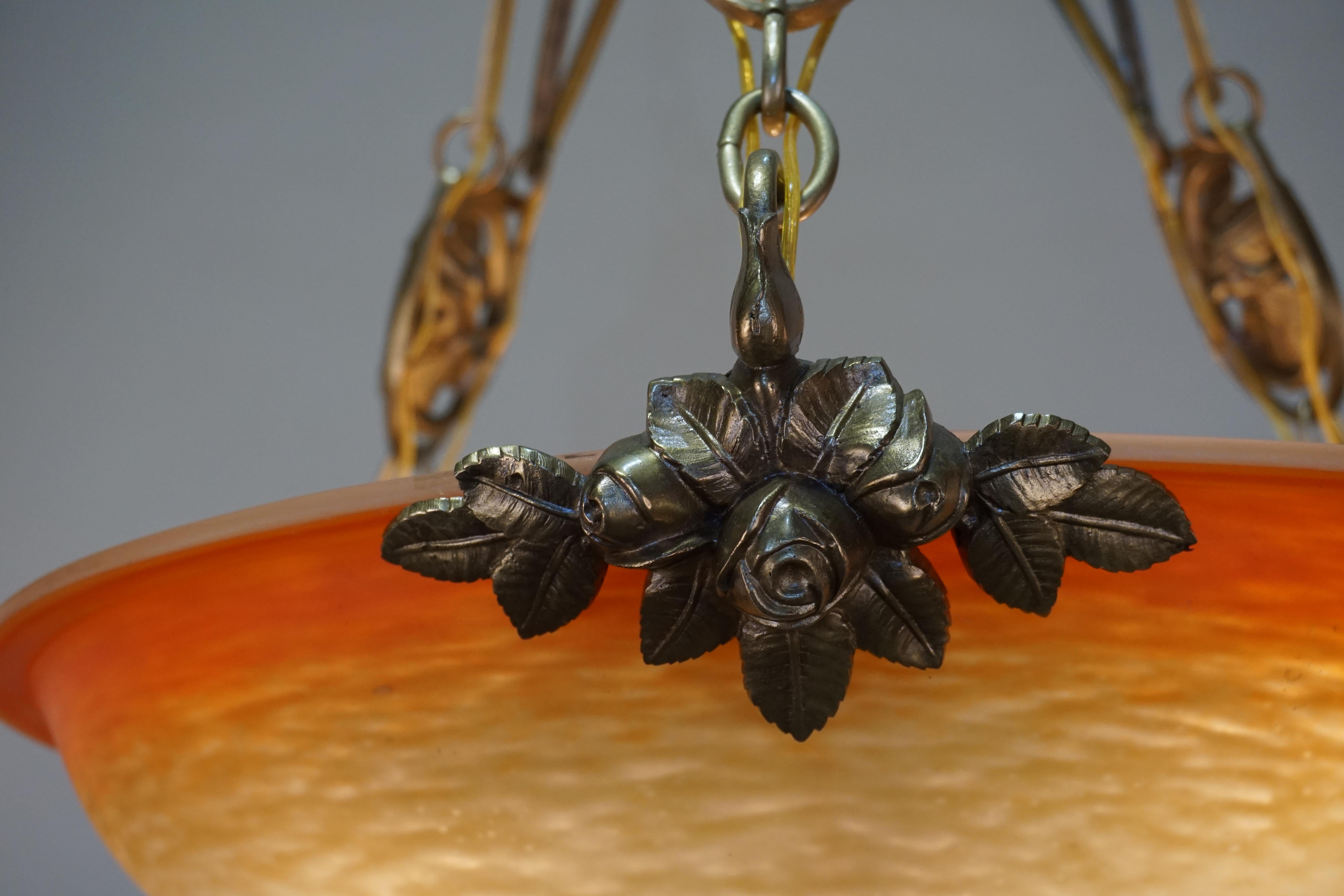 Blown glass chandelier with bronze mounting by Charles Schneider.
Total of nine lights, 60 watt max each.
