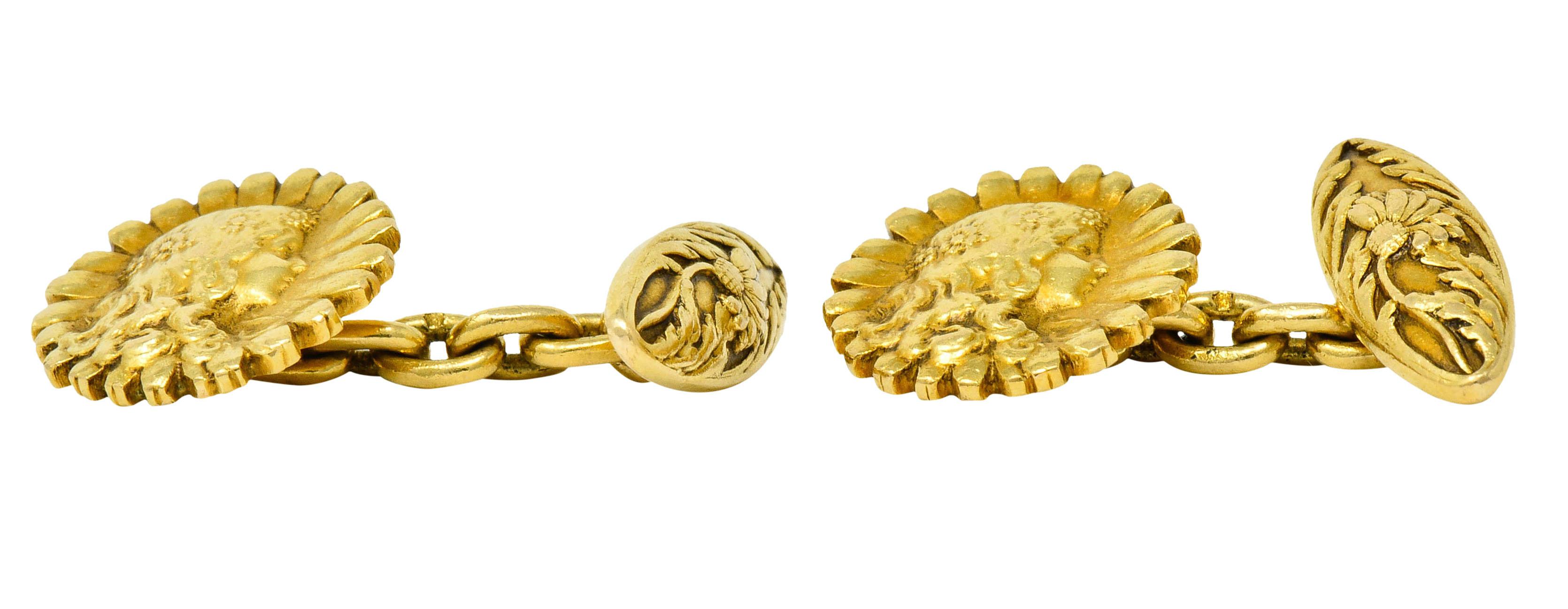 Link style cufflinks terminating as an elongated bar and a daisy

Daisy is highly rendered to depict a young girl with a daisy chain in her hair

Bar is highly rendered to depict a blooming daisy surrounded by whiplash foliate

With maker's mark and