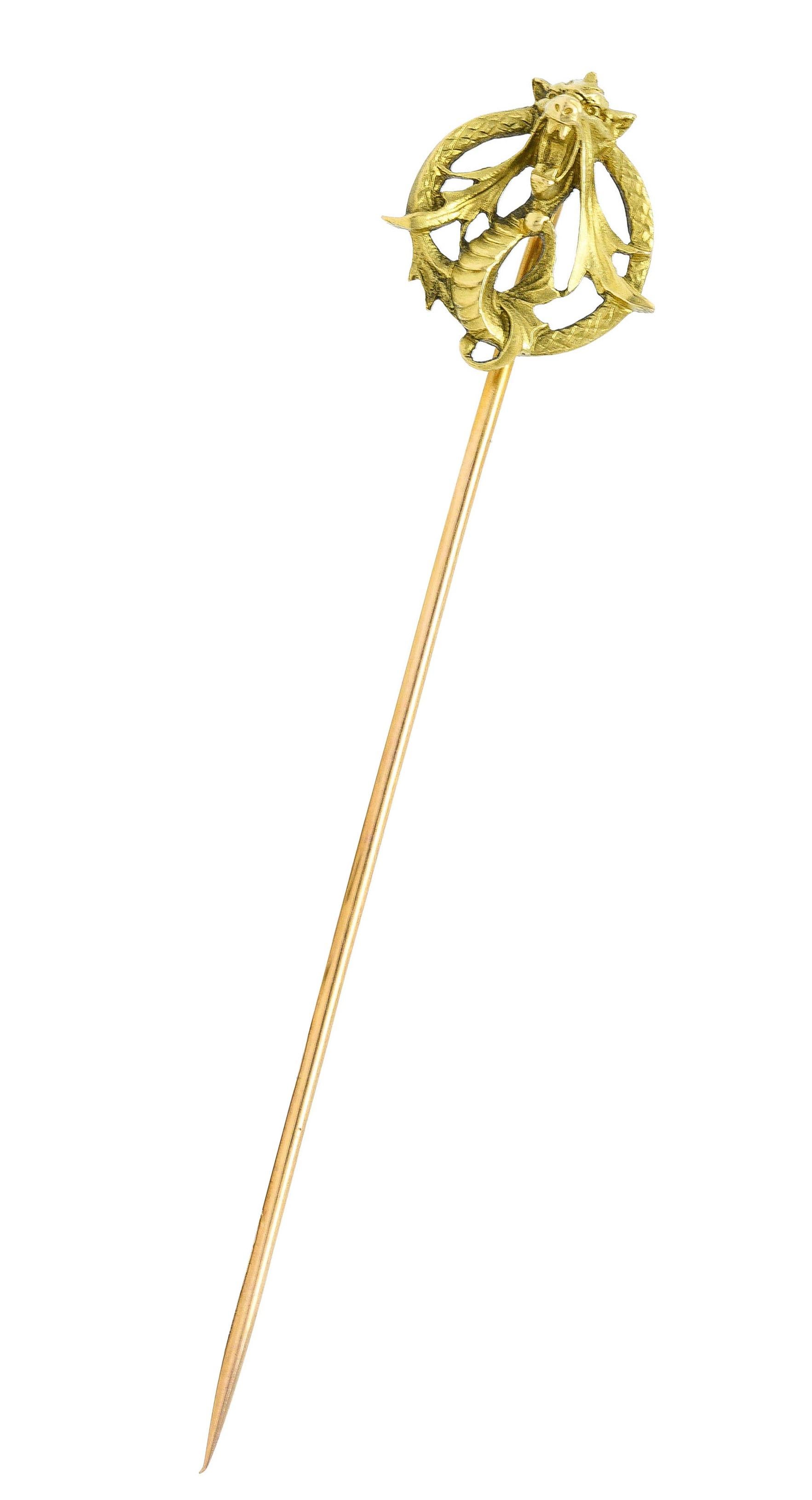 Darstellung eines grün-goldenen Schlangendrachens, der sich in einem Kreis windet

Stilisierte Peitschenschwingen und schraffierte Schuppen

Französisches Prüfzeichen für 18-karätiges Gold

Nummeriert mit französischer Herstellermarke

Um: