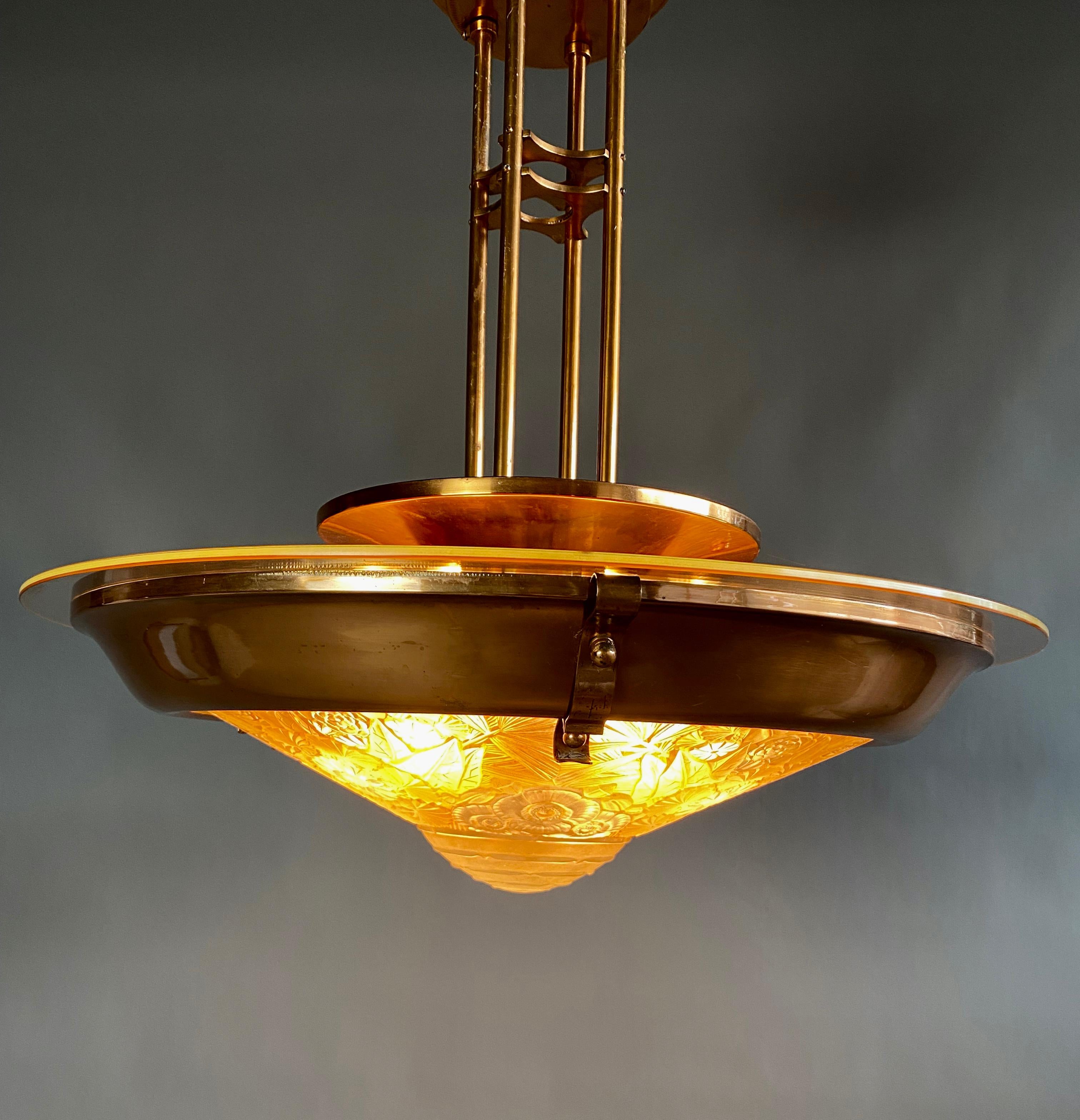 Stylish and classy French Art Nouveau / Art Deco brass and acid etched glass chandelier in the style of Lalique.
The upper brass part rests on top of the glass. It is not fixed but that is how I bought the chandelier.

The chandelier will be shipped