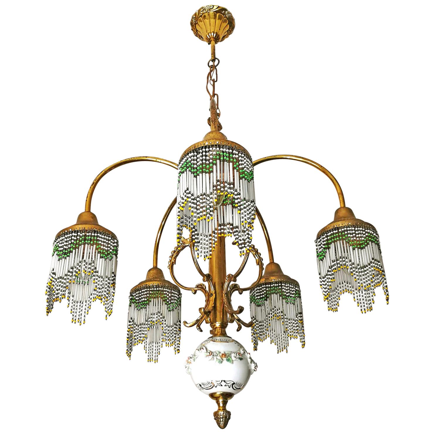 Beautiful French Art Nouveau Art Deco gilded brass, bronze and polychrome beaded fringe lamp shades.
Measures:
Diameter 23.6 in /60 cm
Height 31.5 in (7.8b in/chain) / 86 cm (20 cm/chain)
Weight: 6 Kg / 13 lb
5-light bulbs E-14 / good working