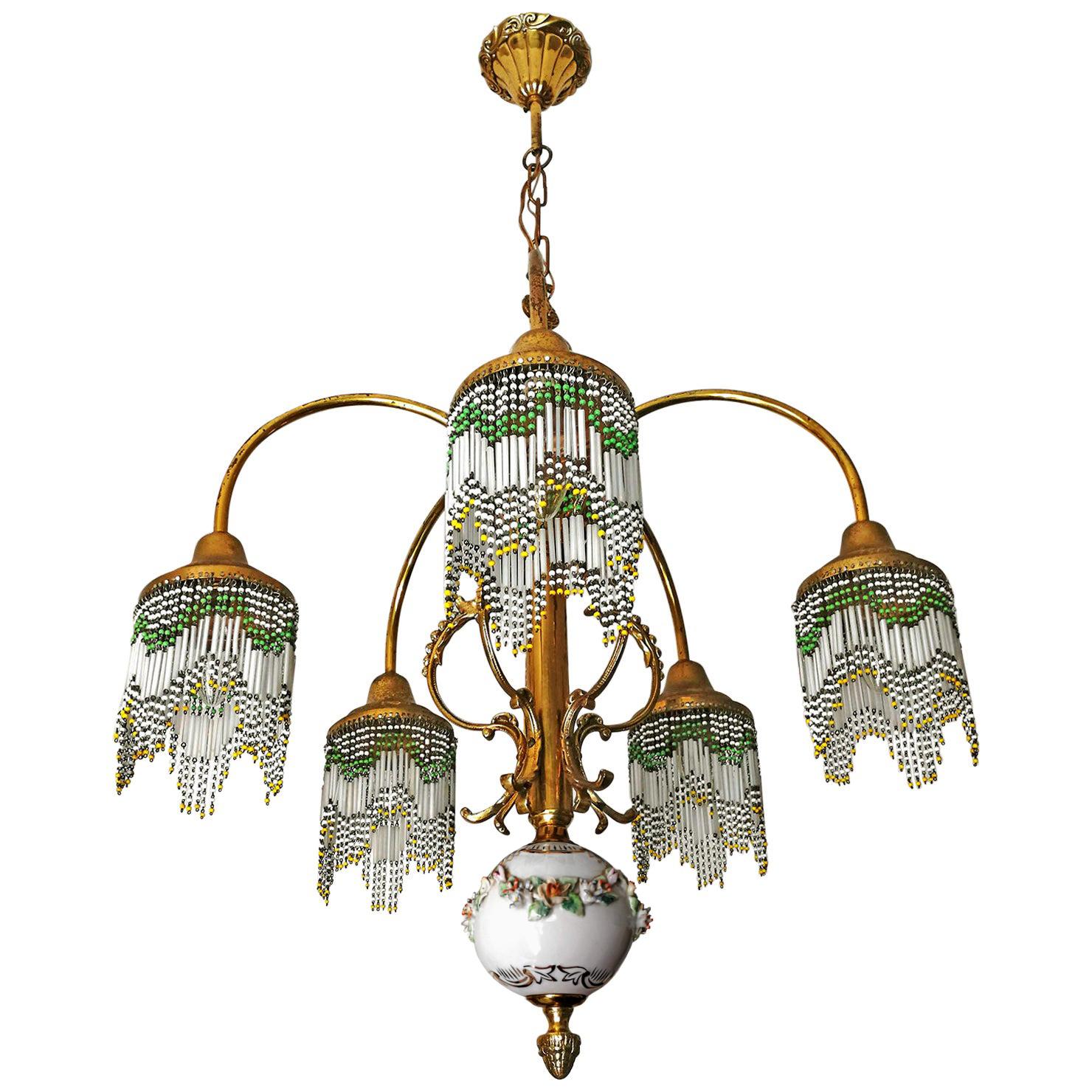 Beautiful French Art Nouveau Art Deco gilded brass, bronze and polychrome beaded fringe lamp shades.
Measures:
Diameter 23.6 in /60 cm
Height 31.5 in (7.8b in/chain) / 86 cm (20 cm/chain)
Weight: 6 Kg / 13 lb
5-light bulbs E-14 / good working