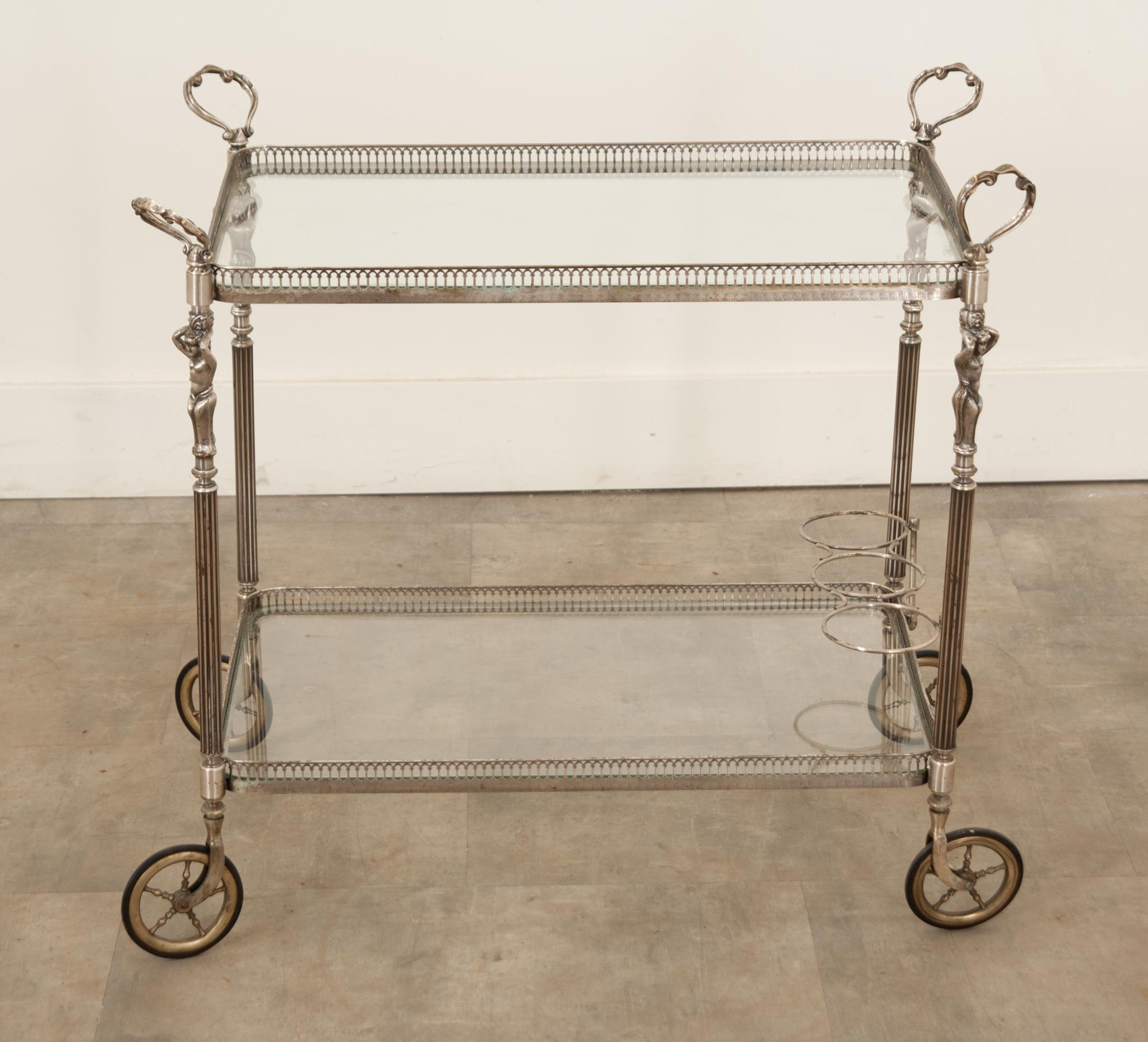 A fabulous French metal bar cart with a silver finish that was hand-crafted in France circa 1900 during the Art Nouveau period. This exquisite trolley is made of metal and contains its original glass. It features a gallery top, four original castors