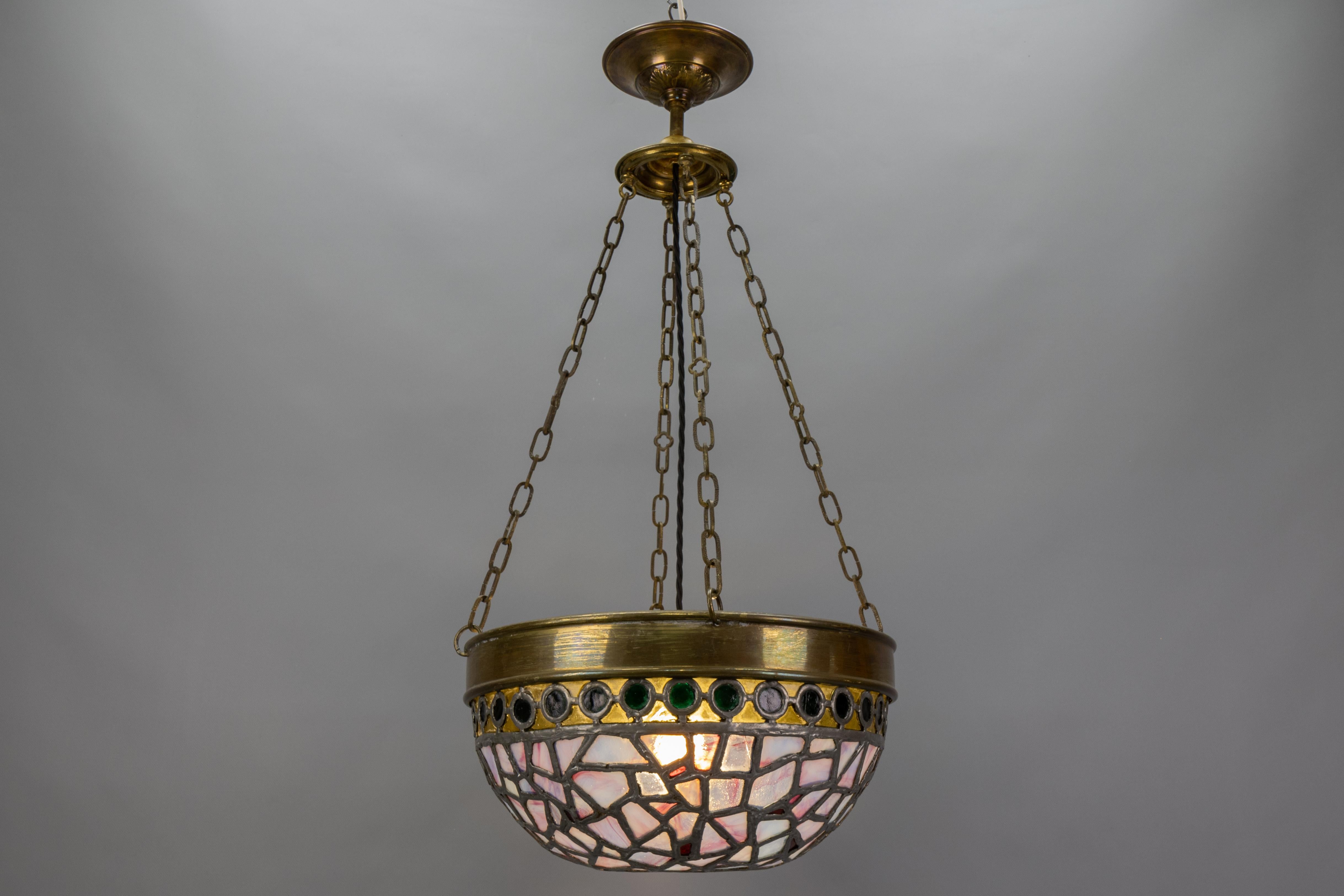 Art Nouveau Blue & Violet Stained Glass Pendant Light with Brass Frame, France, 1920s

This stunning Art Nouveau pendant light features a beautiful stained glass shade in shades of blue and violet, creating a mesmerizing glow when illuminated. The