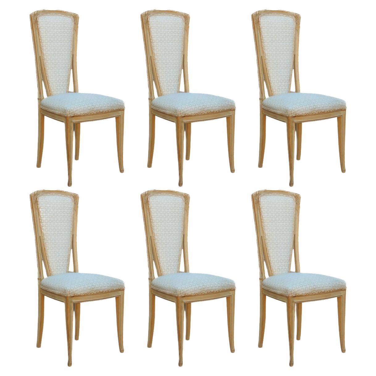 French Art Nouveau dining chairs with carved walnut frames featuring carved floral motif at the tops of each chair, a washed enamel finish and upholstered in a textured Boucle'.  Elegant and graceful.
Set of 6, all identical. Circa 1950's or older,