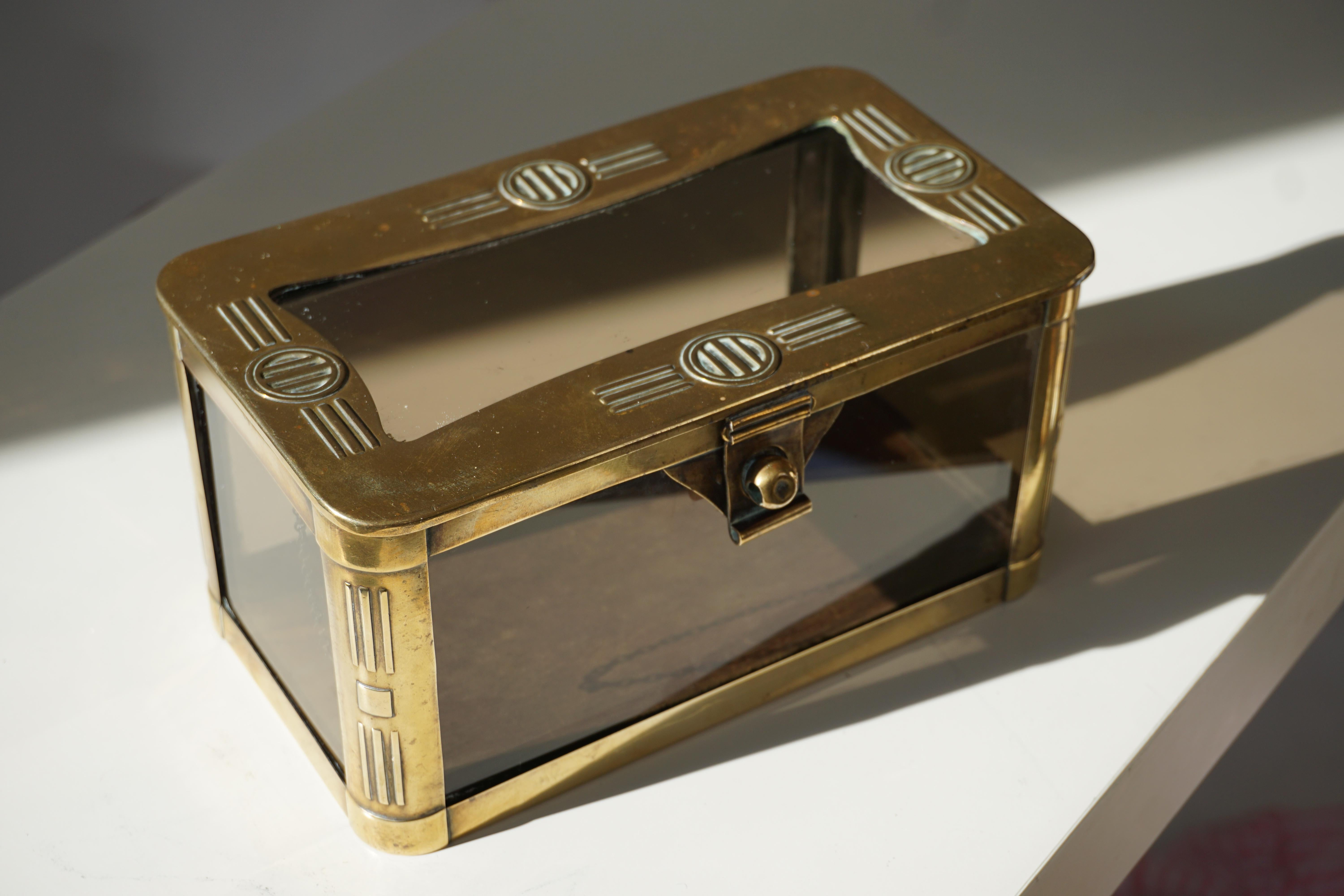 An absolutely splendid French jewelry casket made from brass, retaining the original panels of glass.