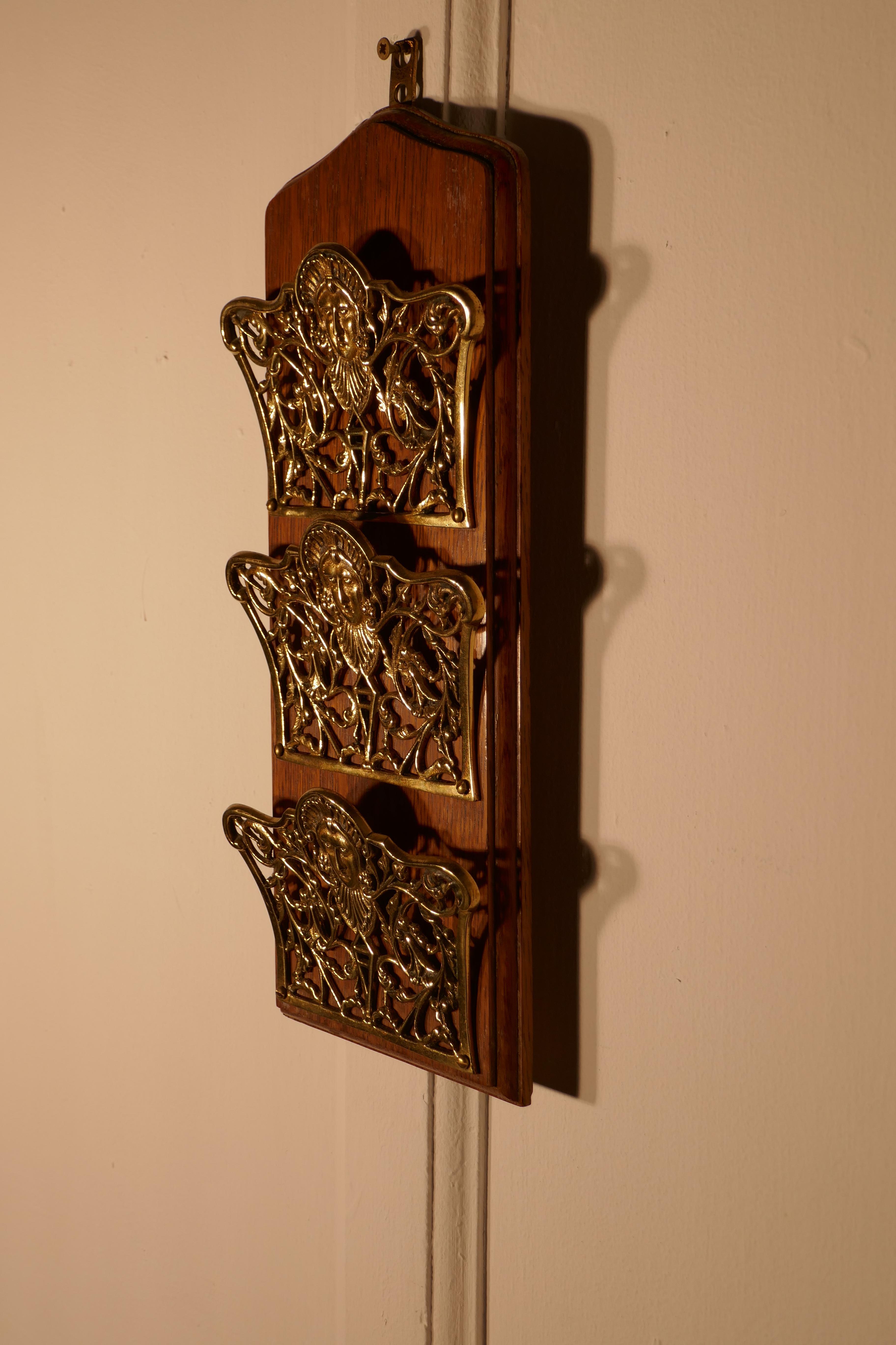 French Art Nouveau brass and oak wall hanging letter rack

3 pierced letter holders set on Oak, the brass is in the Art Nouveau style with faces of caryatid and floral decoration
This lovely and useful piece once a necessity in any reception hall