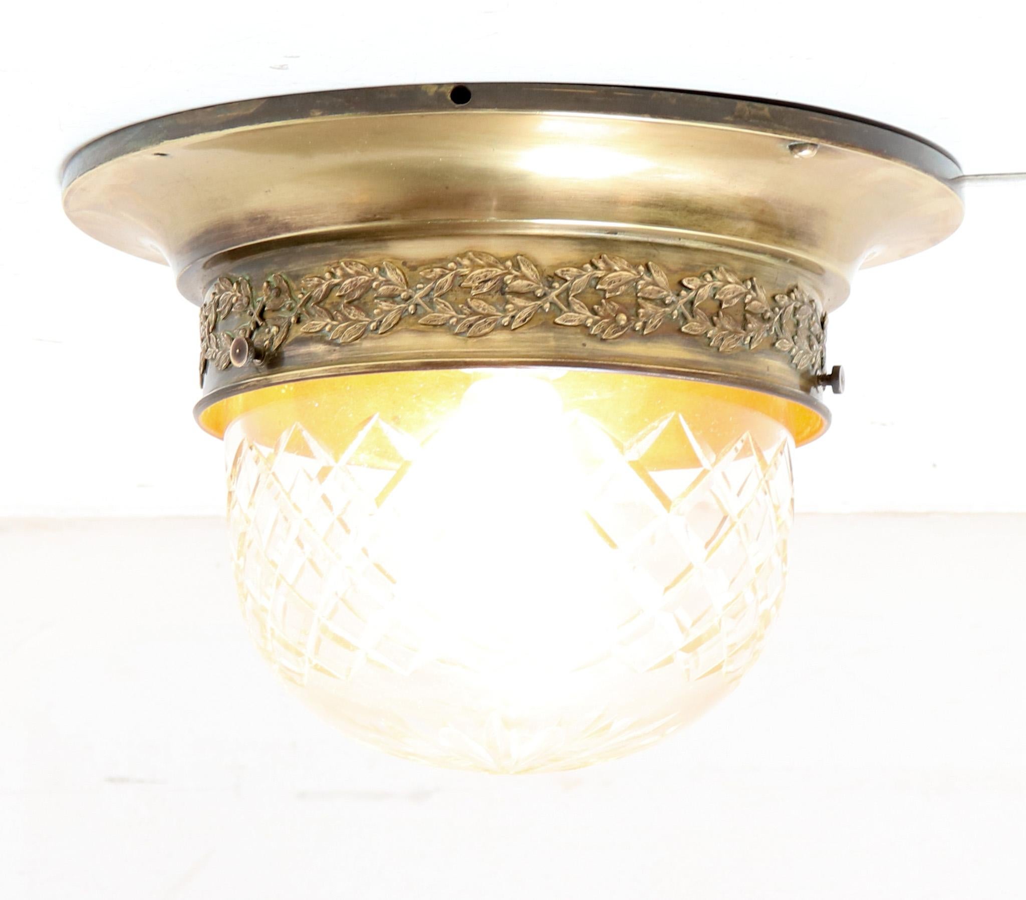 Stunning Art Nouveau flush mount ceiling light. Striking French design from the 1900s. Original patinated brass frame with original hand blown cut glass shade. Rewired with one original socket for E-27 light bulb. This wonderful Art Nouveau flush