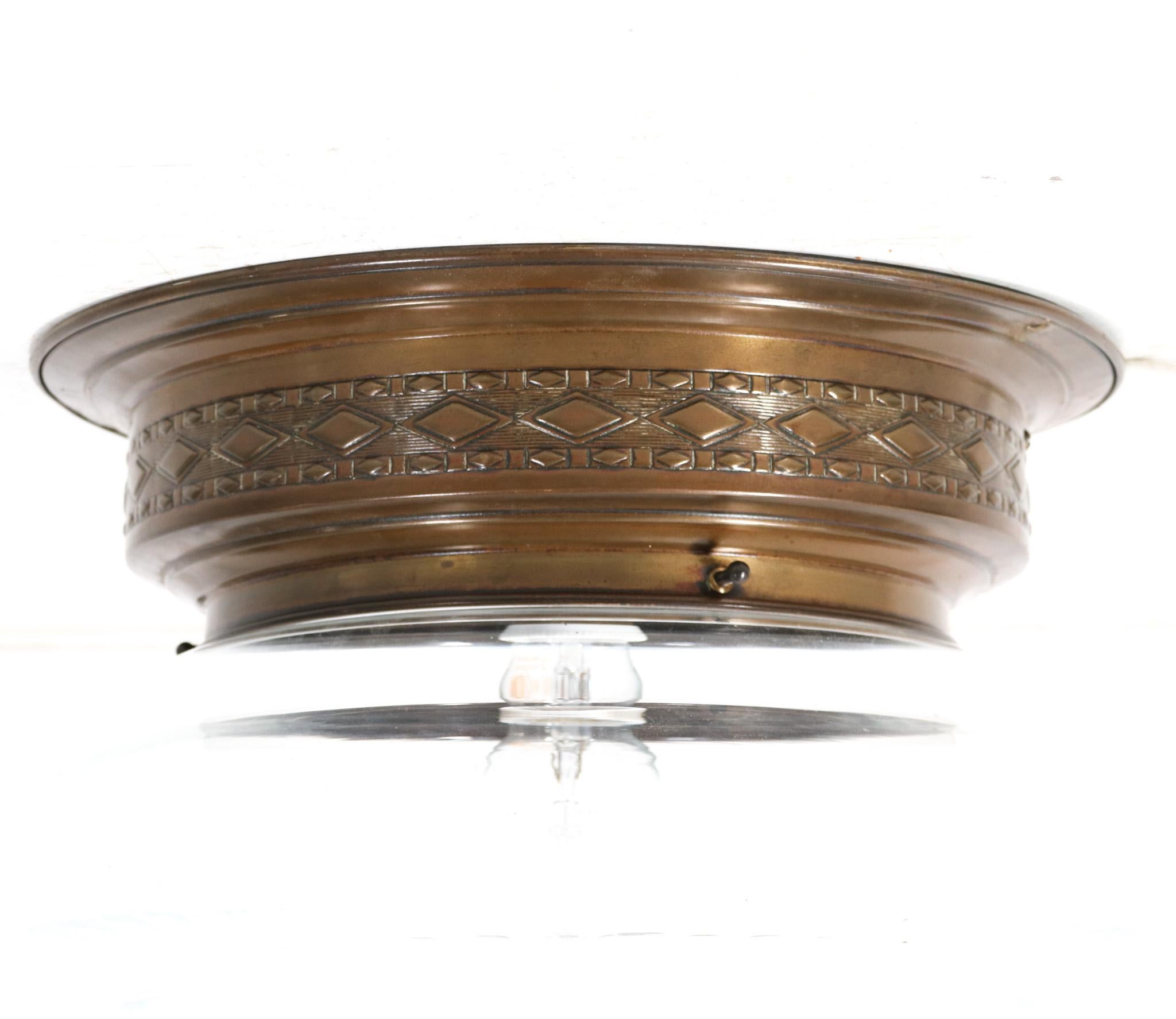 Stunning Art Nouveau flush mount ceiling light. Striking French design from the 1900s. Original patinated brass frame with original hand blown cut glass shade. Rewired with one original socket for E-27 light bulb. This wonderful Art Nouveau flush