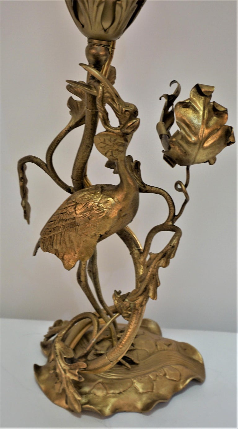 French art nouveau table lamp with late 19th century bronze base and early 20th century art glass shade.