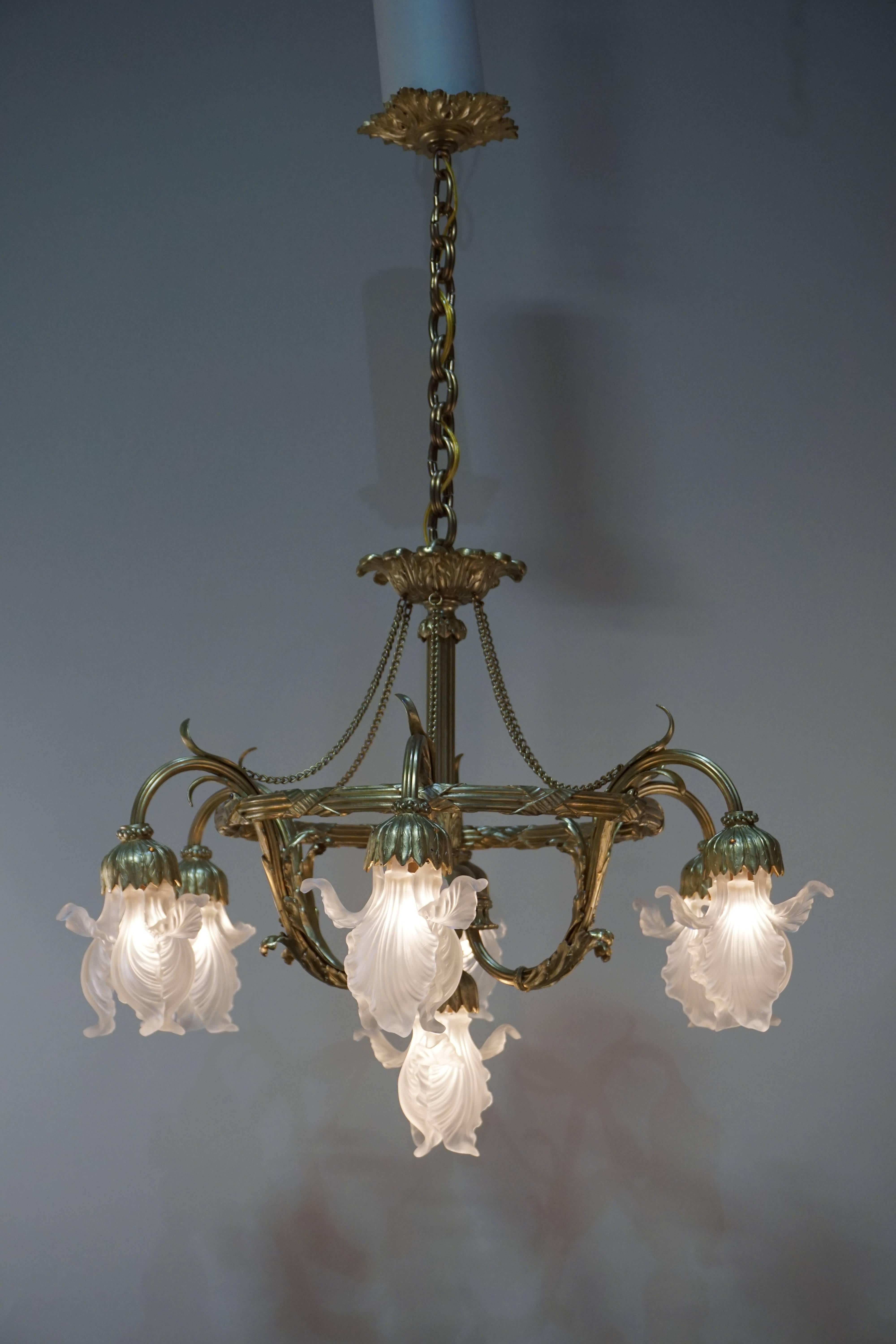 Elegant seven light bronze and Art Nouveau chandelier with six part glass tulip shades. 
Total height is 39