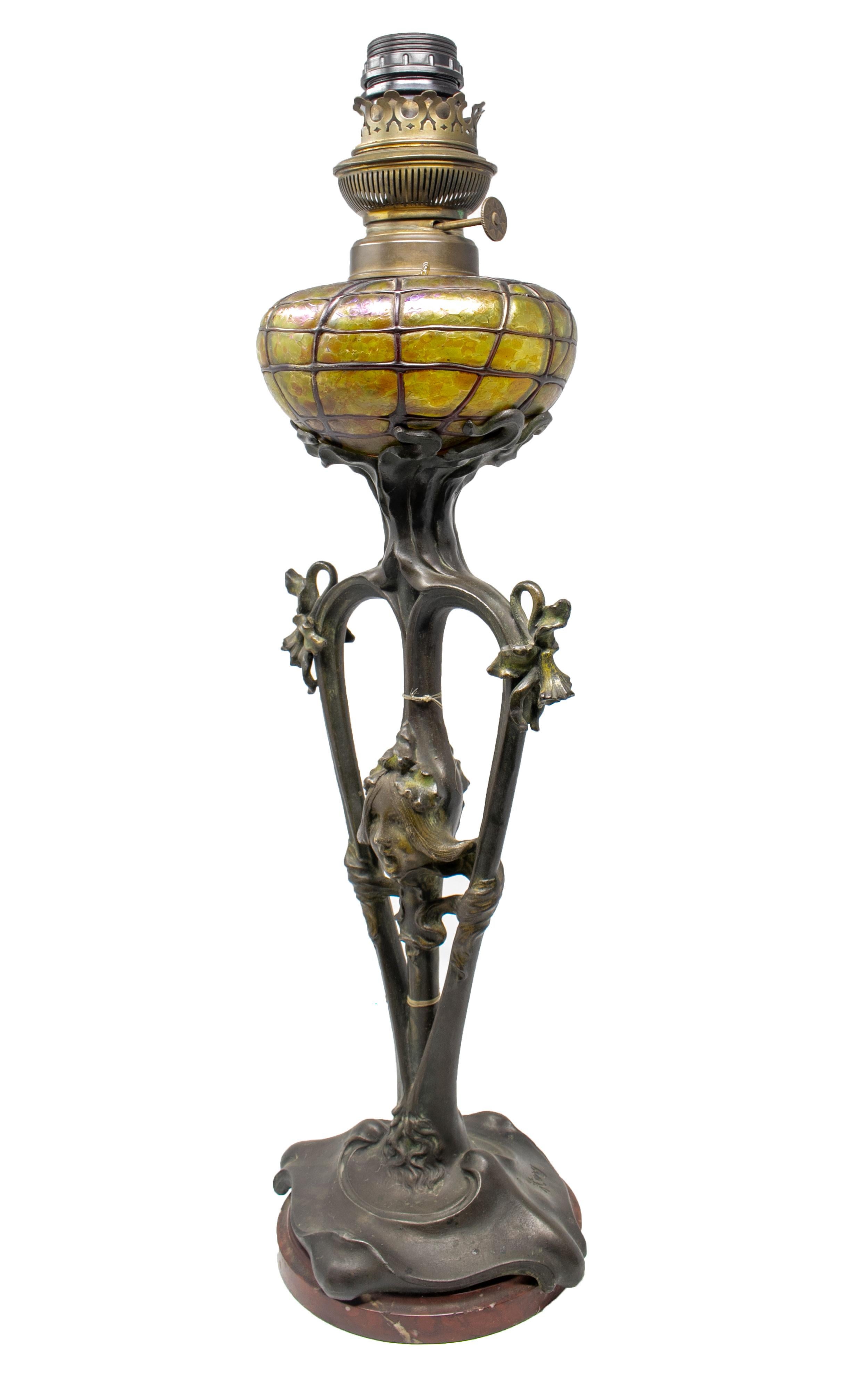 French Art Nouveau bronze and glass lamp signed on the base.