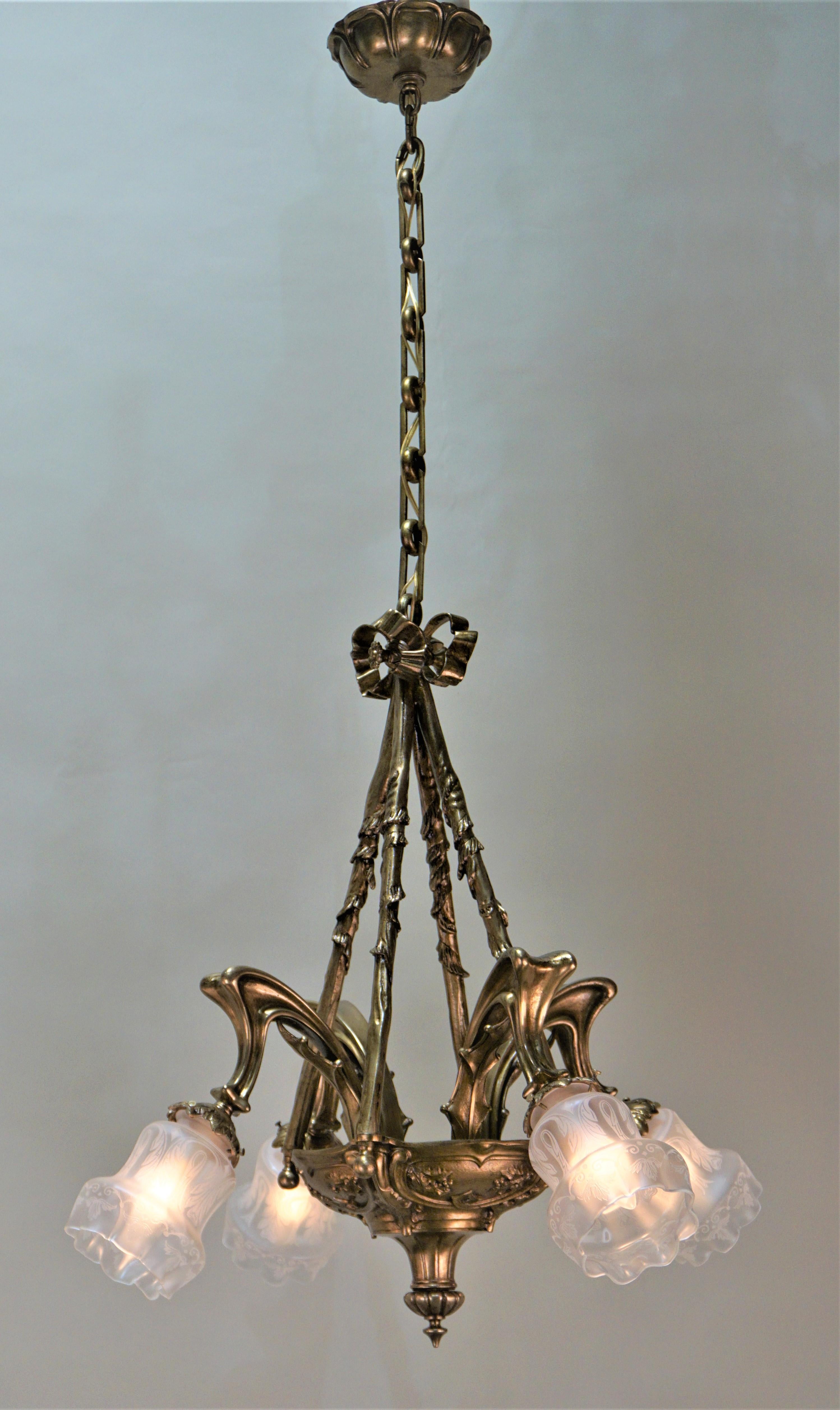 Early 20th century four-light bronze chandelier with etched glass shades.
Total height with all the chain is 44.5