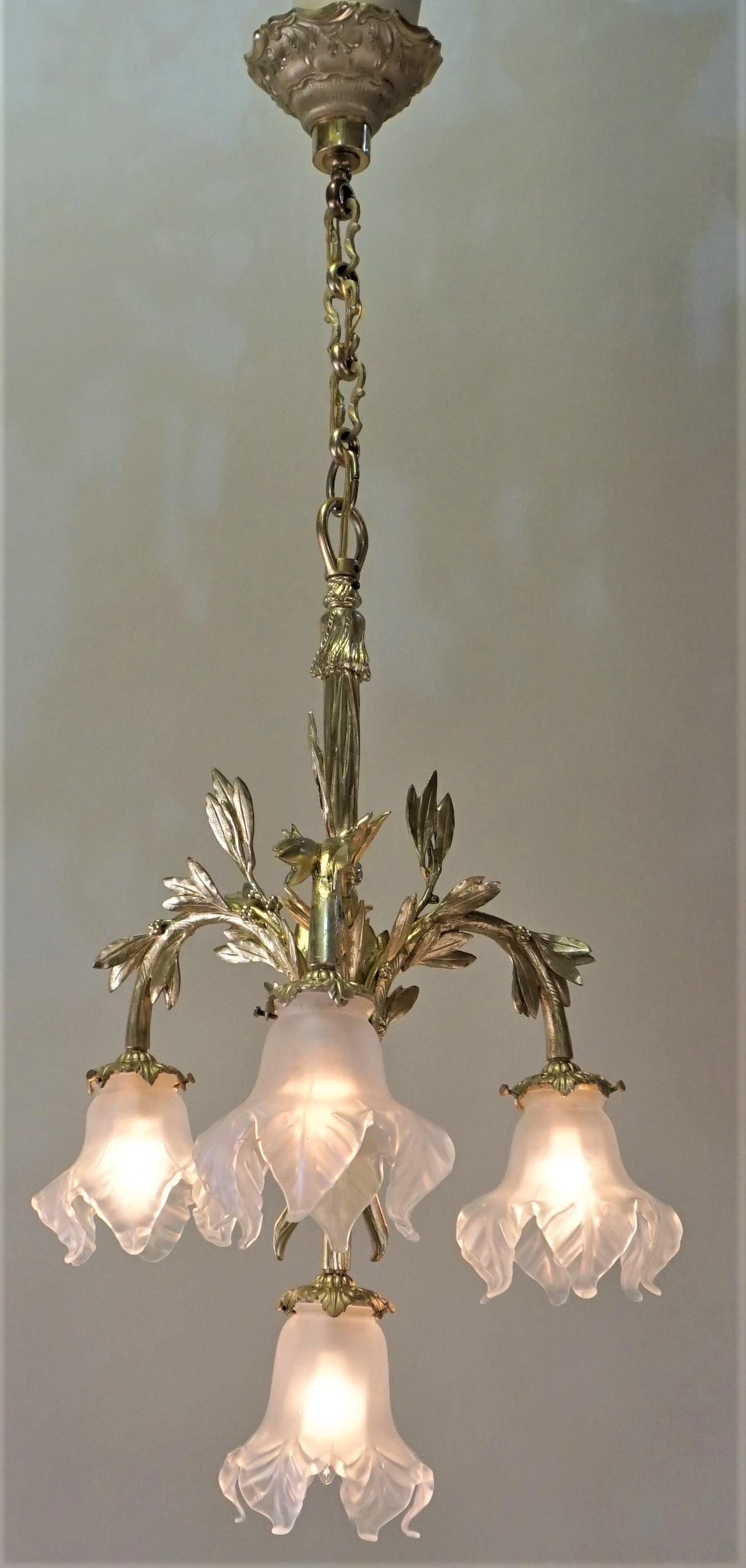 Beautiful four branch golden bronze Art Nouveau chandelier with clear Frost glass shades.