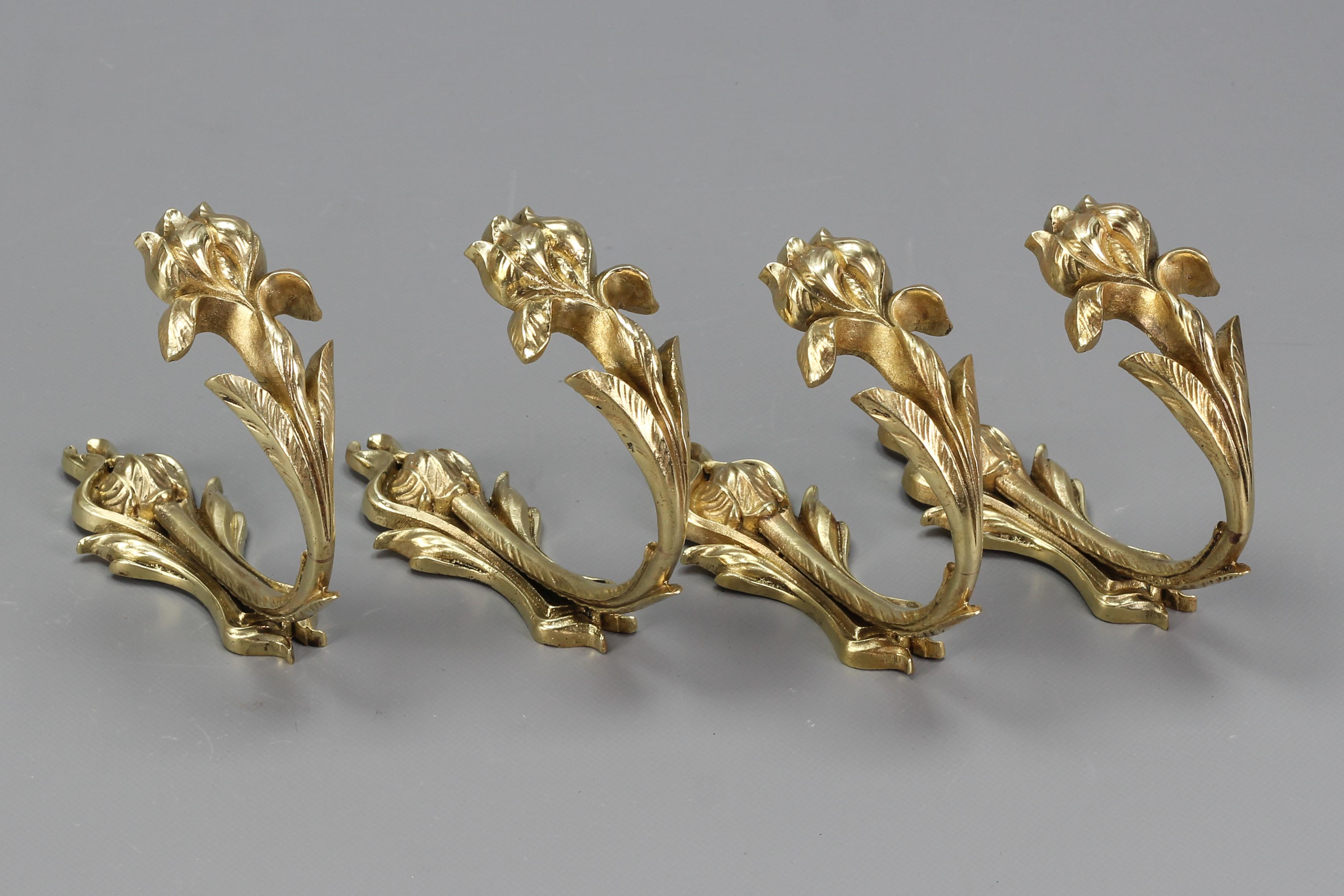 French Art Nouveau bronze curtain tiebacks or curtain holders iris, set of four.
A beautiful set of four Art Nouveau bronze curtain holders or supports, or tiebacks in the shape of an iris flower. 
Each curtain holder is marked and numbered.