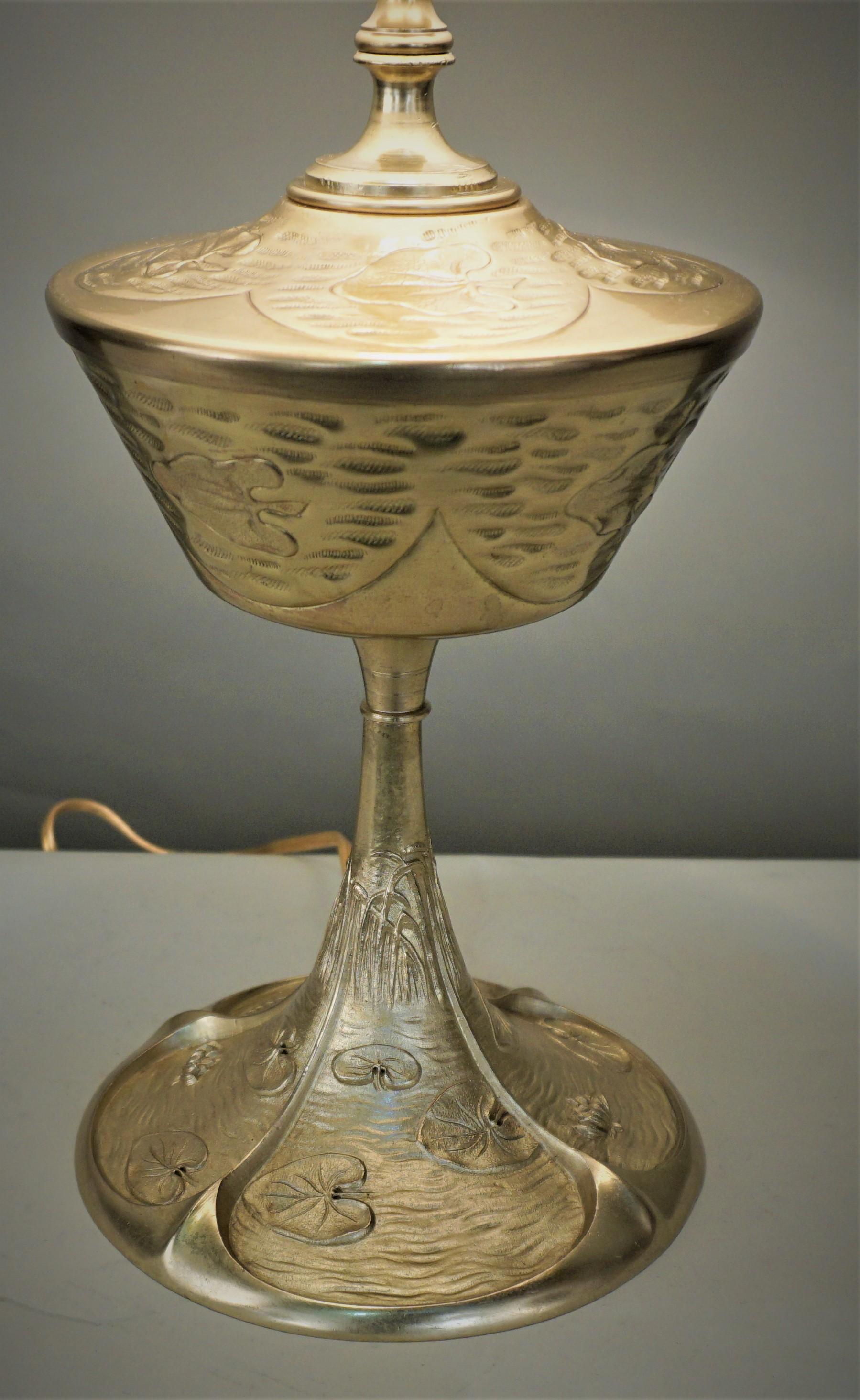 Late 19th century oil lamp base that has been electrified and fitted with silk lampshade.