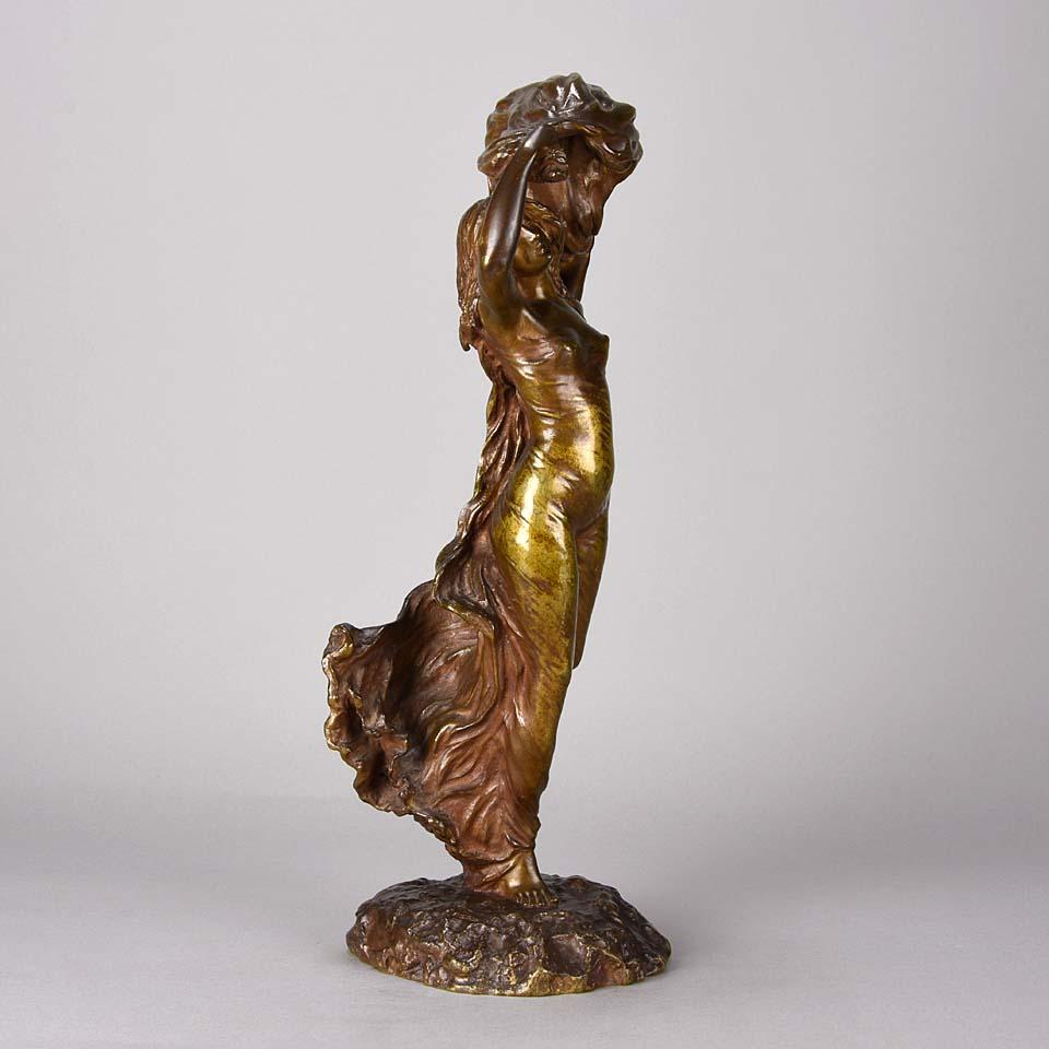 A charming early 20th century Art Nouveau bronze study of a beautiful dancing lady dressed in a loosely fitted dress and shawl blowing above her head with very fine detail and wonderful rich brown colour, signed

Léon Delagrange (1872-1910) was