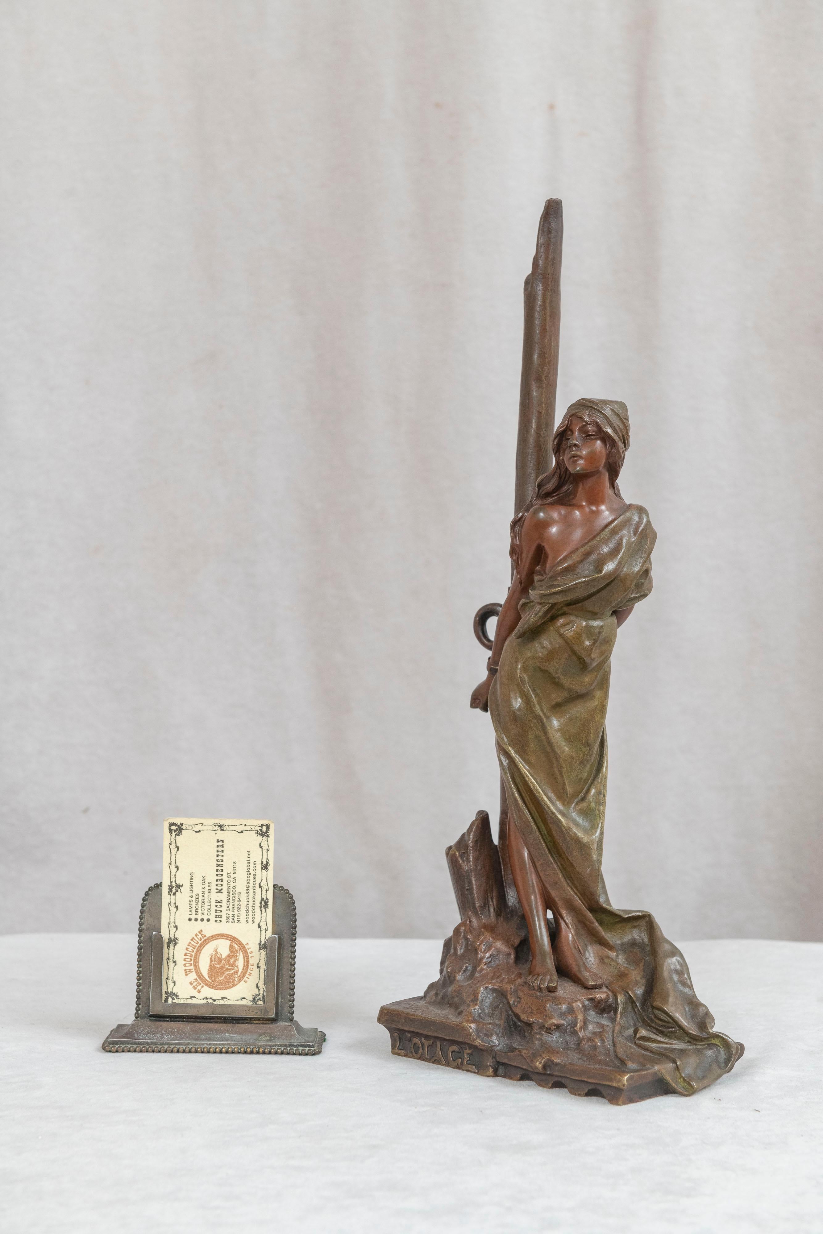 This beautiful Art Nouveau bronze displays the maiden chained to a tree, and titled L'Otage (The Hostage). She is beautifully patinated in brown and green, a greater way of expressing the subject. Emmanuel Villanis (1858-1914) was one of the more