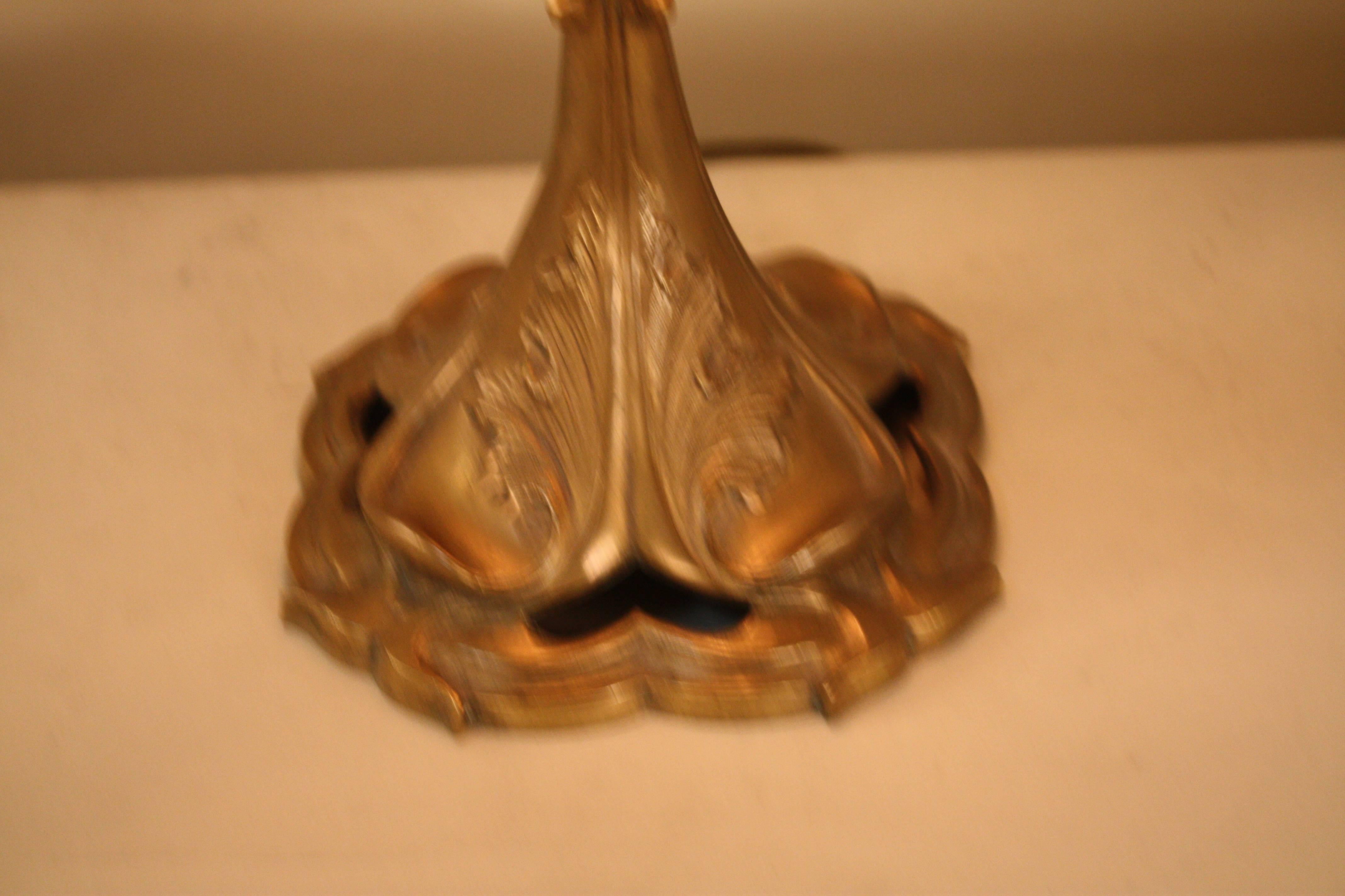 French bronze table lamp, circa 1900-1910, with glass jewel and fringe shade.