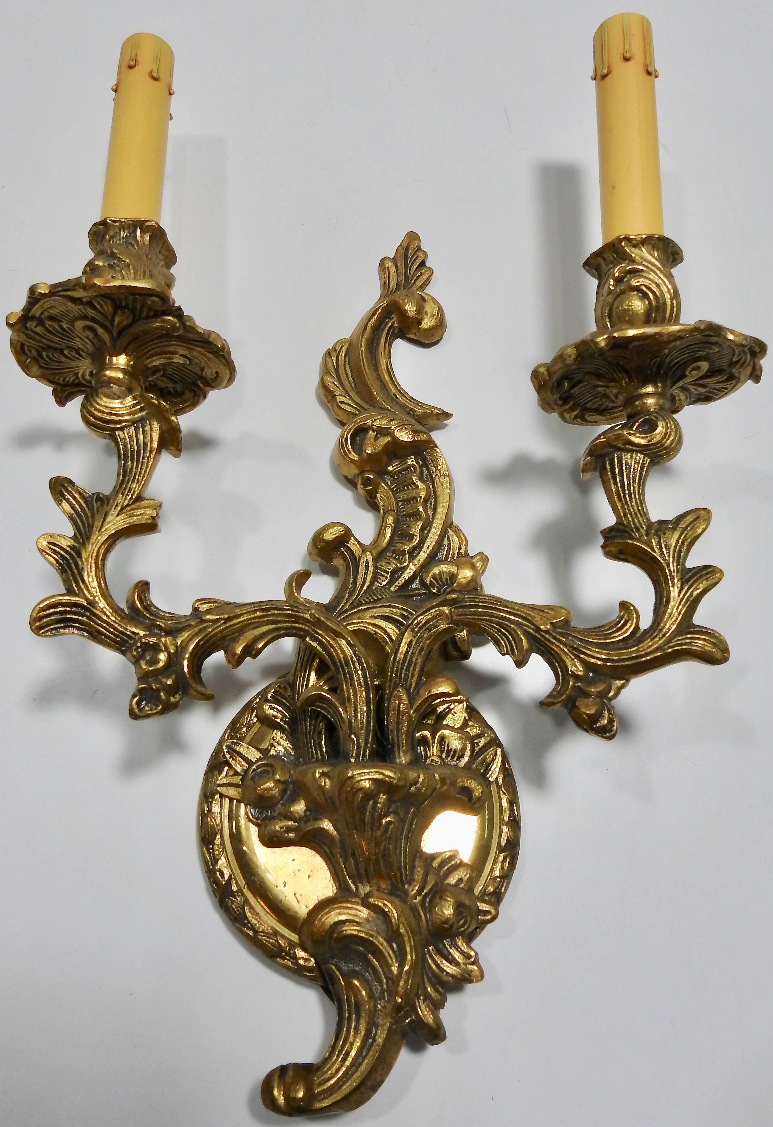The Art Deco period brought out stunning designs! This pair of sconces is a prime example of that. Each sconce features scrollwork with sprinkles of flowers. The sconces have been rewired and fiberboard candle covers added. They are ready to add