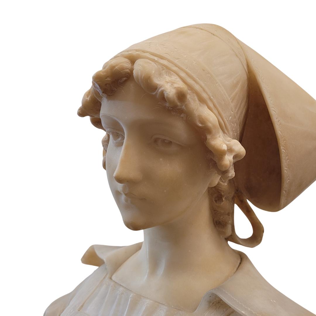 Beautiful and very refined  alabaster bust depicting a young woman with her head slightly bowed, in a reflective or prayerful attitude, made around 1900 in France. It is part of the cultural fashion that encouraged groups of painters in the second