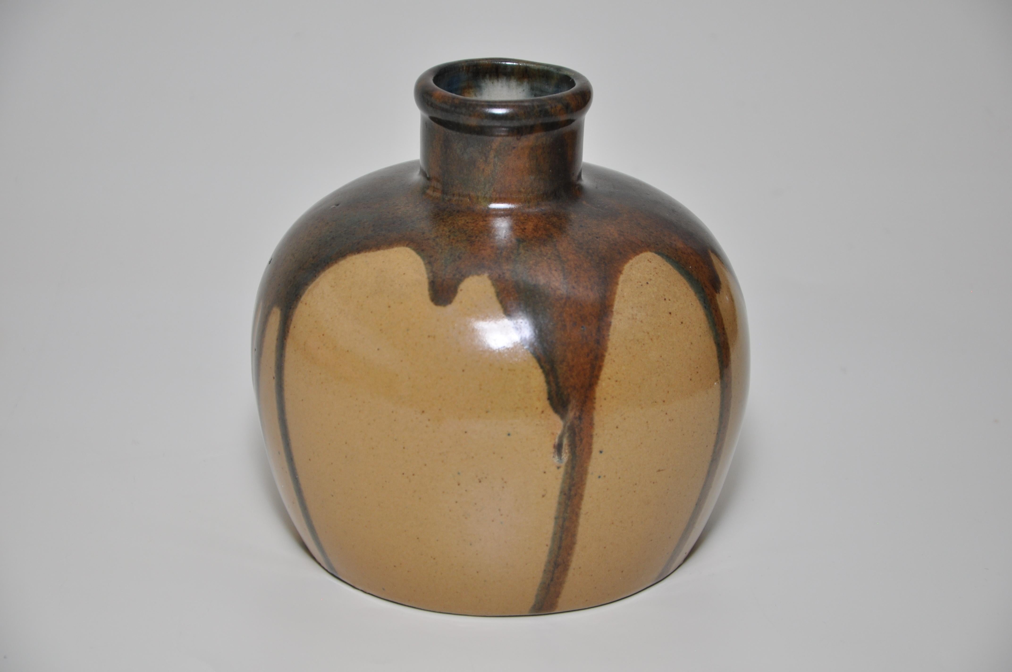 French Art Nouveau pot. 
An attractively drip glazed pot, of bulging squat bottle form, with a very prominent and dramatic flowing brown glaze over a subtle ochre body. 
Of Japanese inspiration. 
Bares the incised signature of ‘Leon Pointu’, son