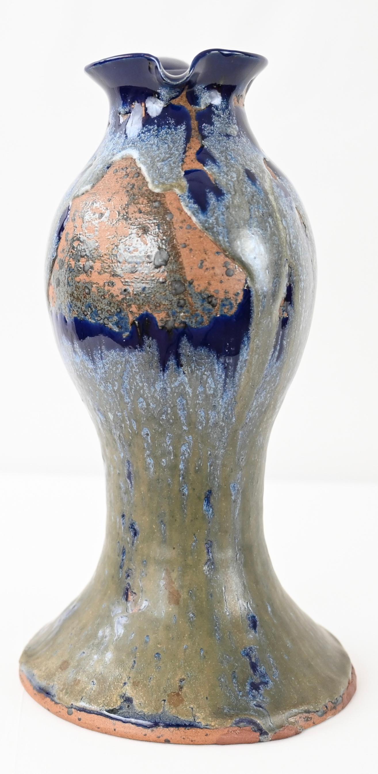 Gorgeously glazed in blue, gray, white and coral hues, this vase in pitcher form has a classic, French Art Nouveau silhouette. This piece was hand-crafted in France using traditional pottery making techniques. Attributed to Charles Greber. Signed.