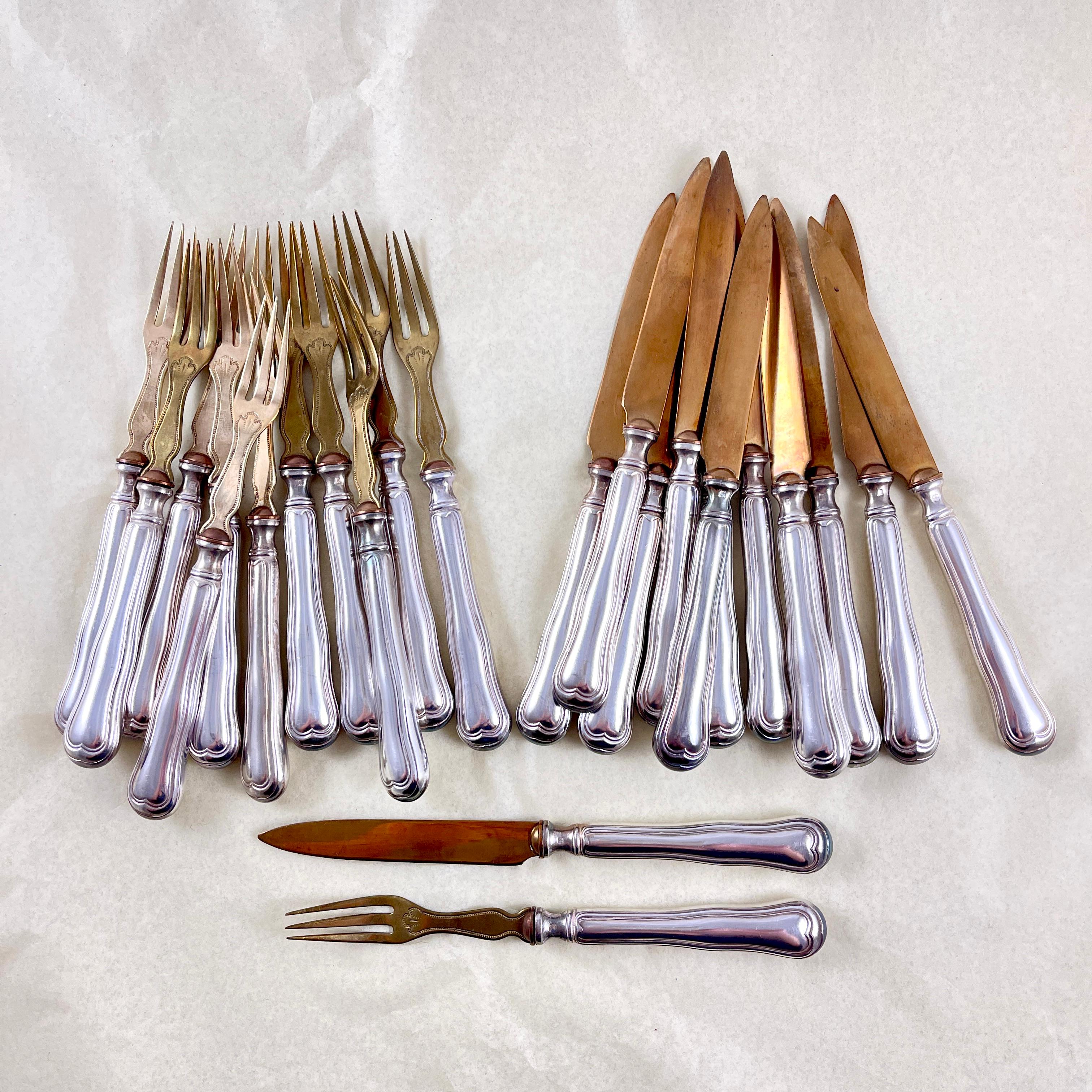 
A set of twenty-four Art Nouveau period forks and knives made by Dominique Capmartin, circa 1900 – 1910.

Sized for the cheese and fruit or dessert courses for the French table, the silver plate and brass service consists of twelve each forks and