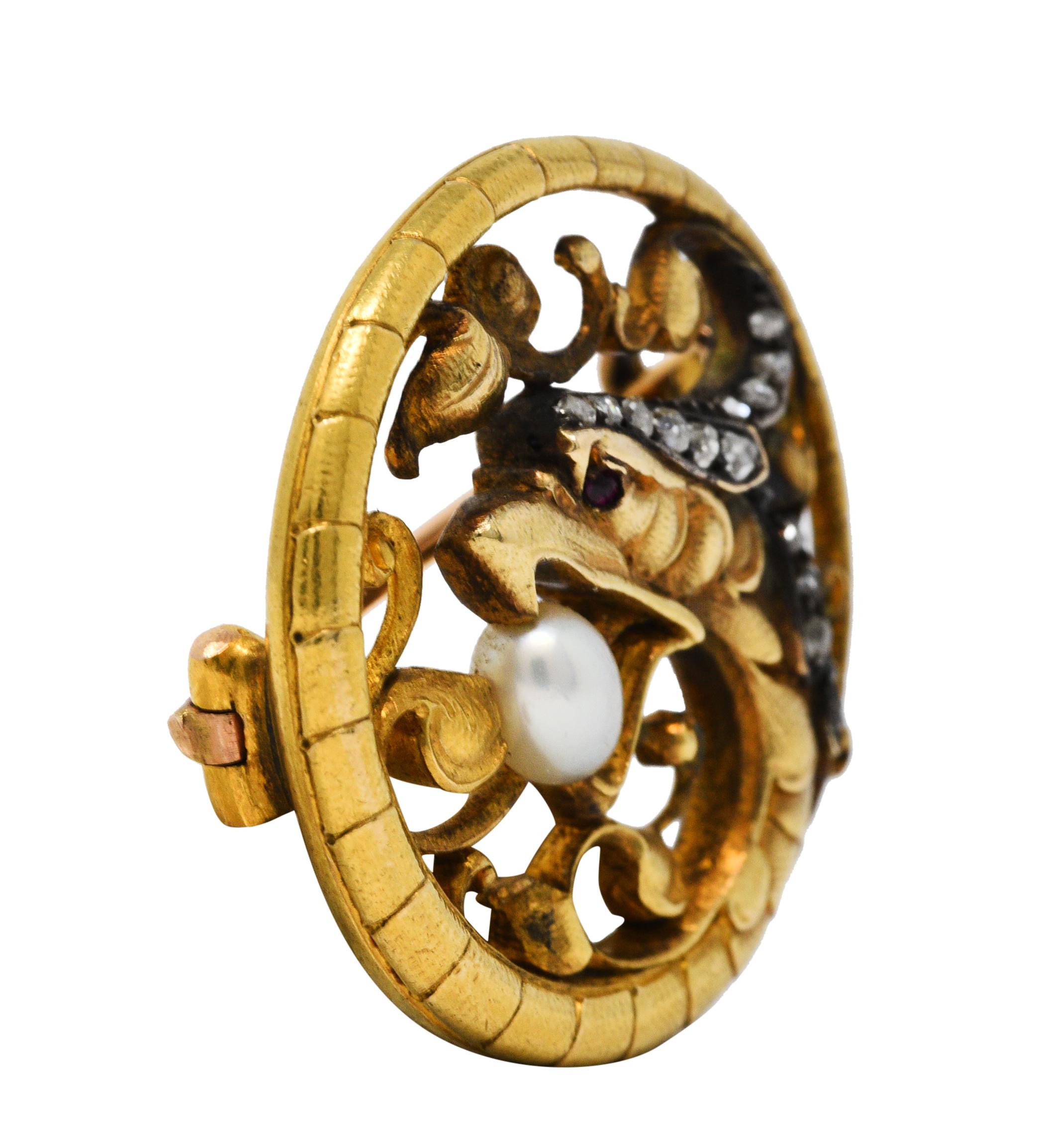 Designed as a beaked basilisk encircled by its serpentine tail

Eye is a round cut ruby while crown is silver-topped and accented by rose cut diamonds

Featuring an oval pearl measuring approximately 5.0 x 4.0 mm

White with strong iridescence and