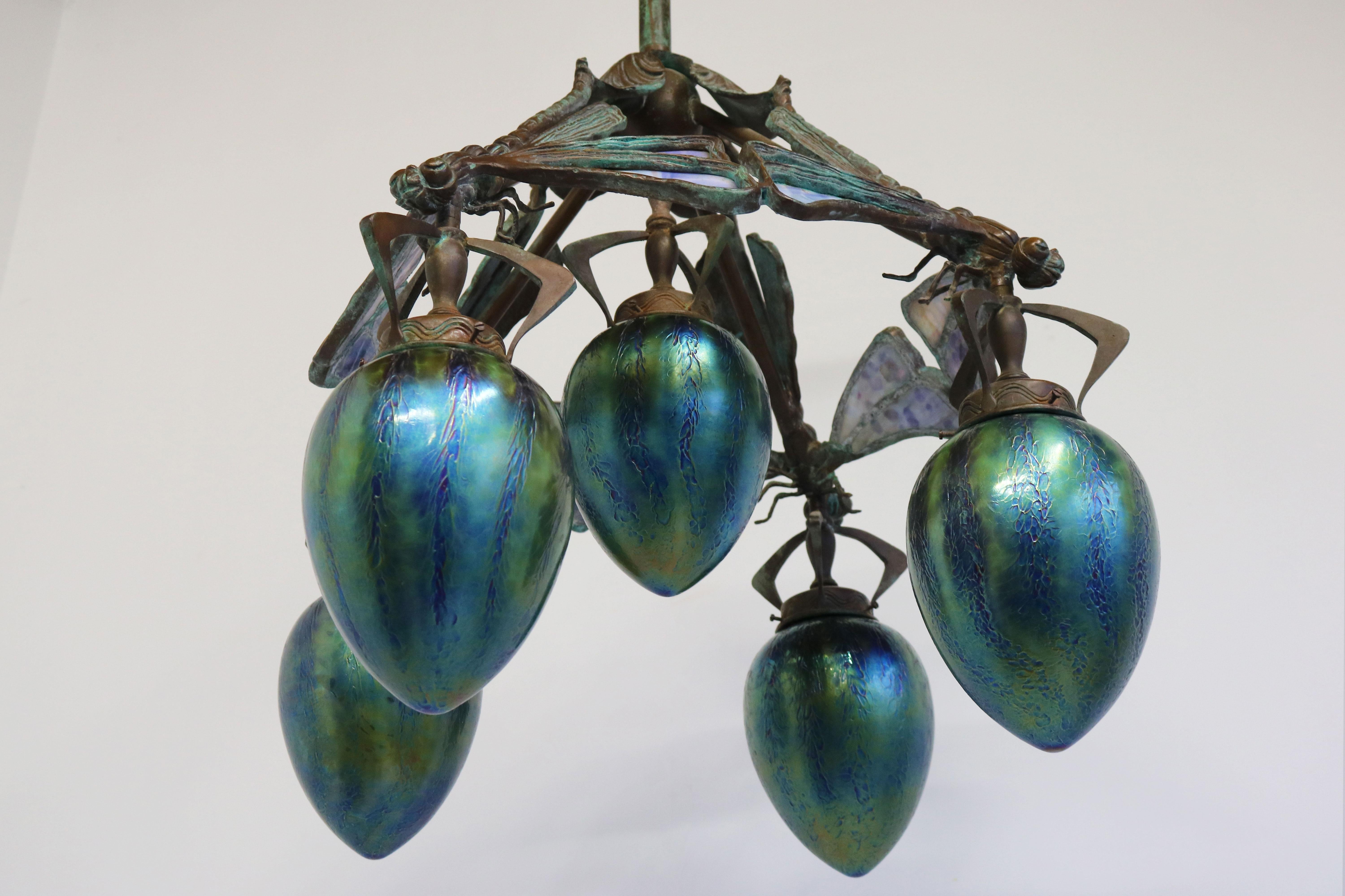 Breathtaking & exceptional! This most rare French Art Nouveau bronze Dragonfly chandelier fully original 1900s. 
Superb art nouveau style & quality with stained glass wings and gorgeous Iridescent Glass shades. 
Each of the four dragonfly has 4