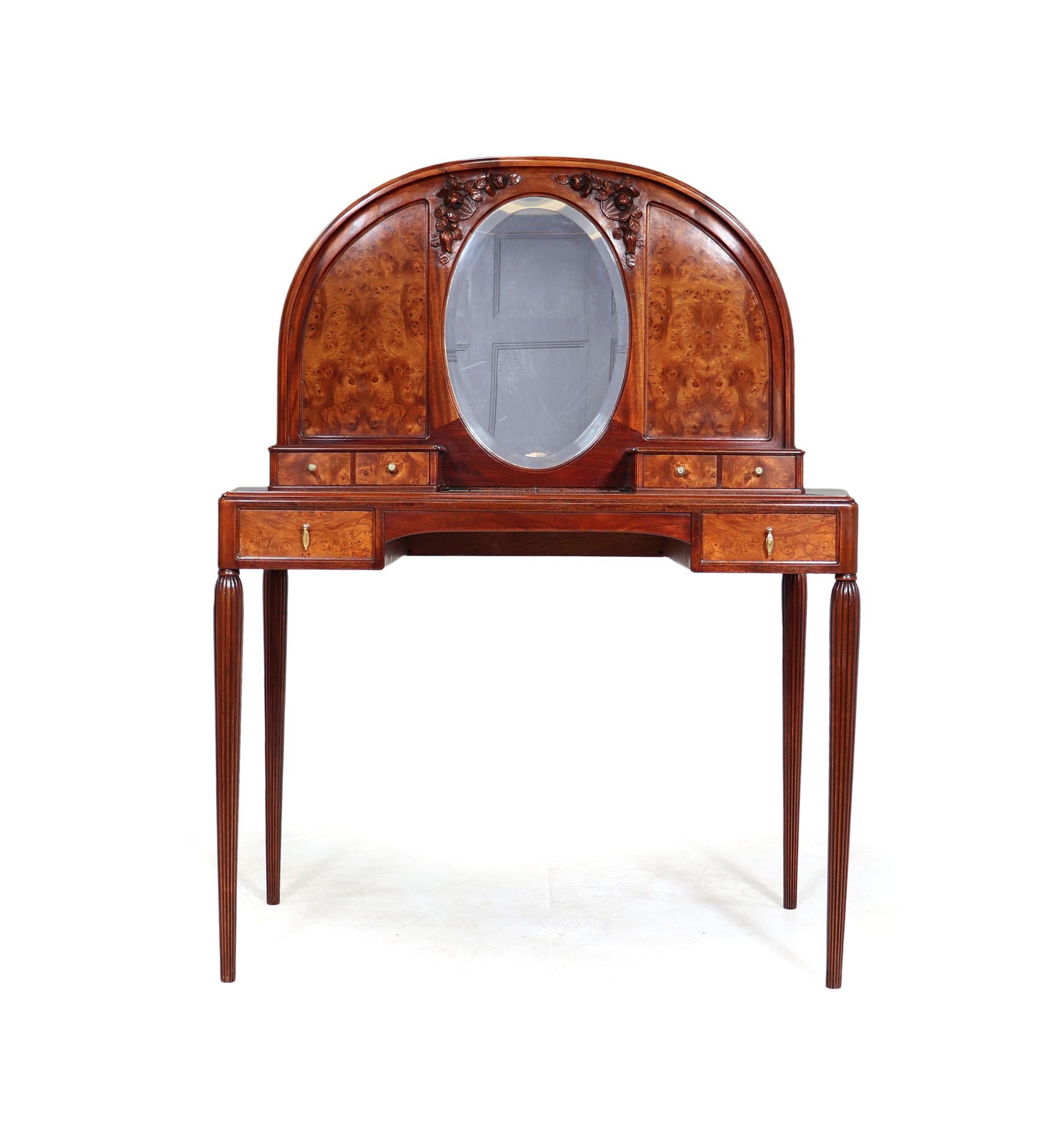 Art Nouveau dressing table
This French Art Nouveau dressing table is made of high quality Burr Elm wood and Mahogany. The table is intricately designed with oval bevelled mirror surrounded by beautiful carving work. The dressing table is the