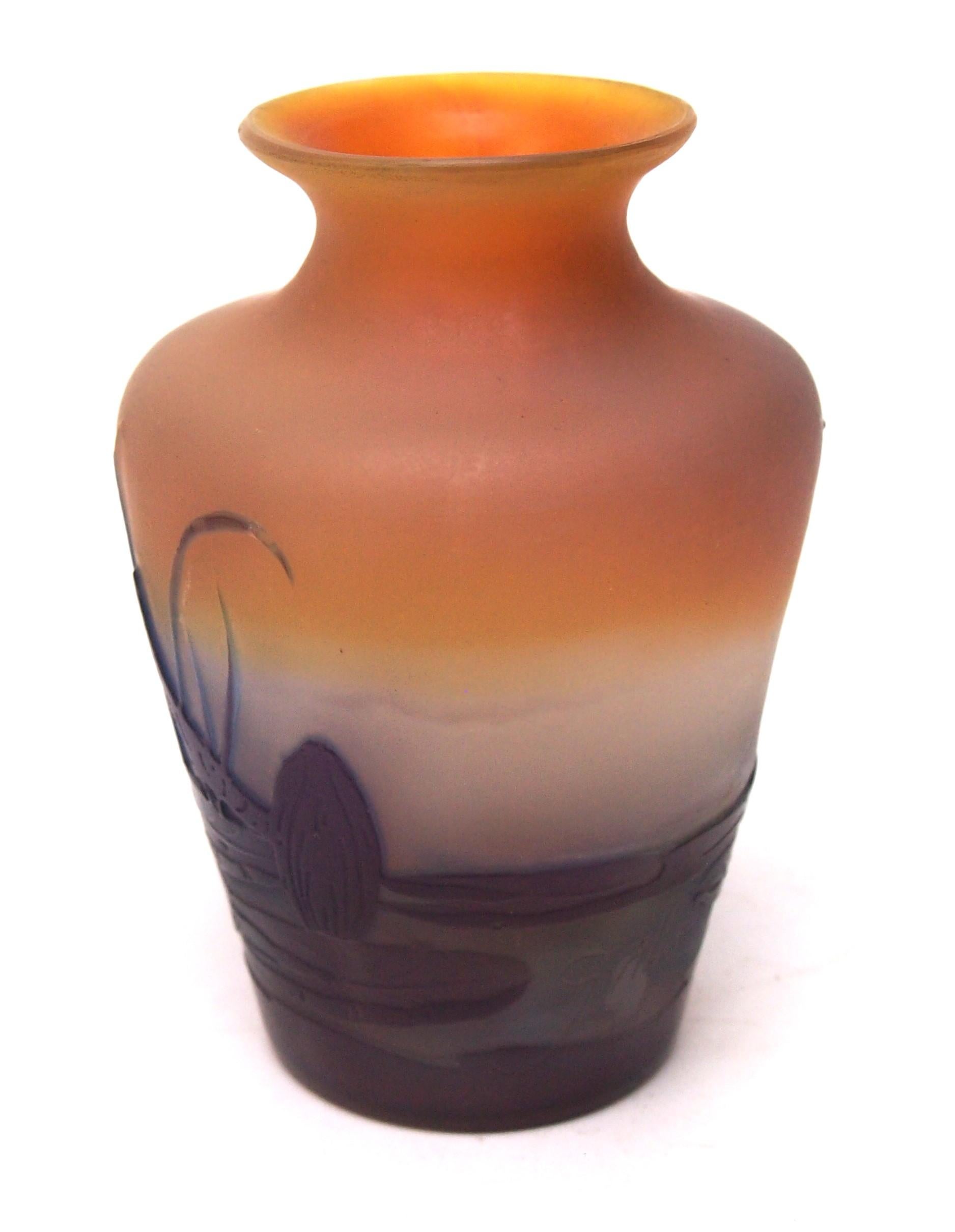 Fabulous and cute small three colour Emile Galle cameo aquatic vase in purple and orange over an unusual opal layer depicting a pond scene with budding and flowering Nénuphars (waterlilies), grasses and Flèche d’eau, Sagittaria (arrow head leaves).